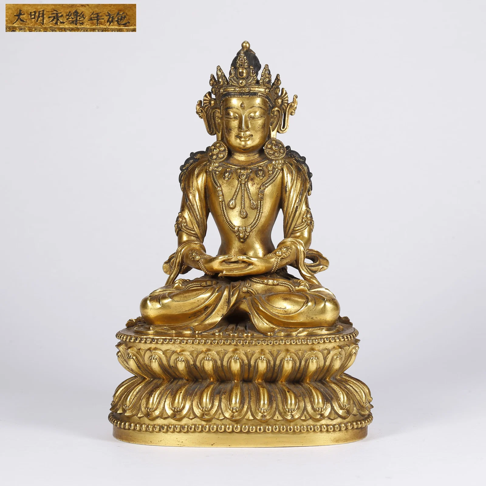 A GILT BRONZE SHAKYAMUNI WITH CROWN STATUE
