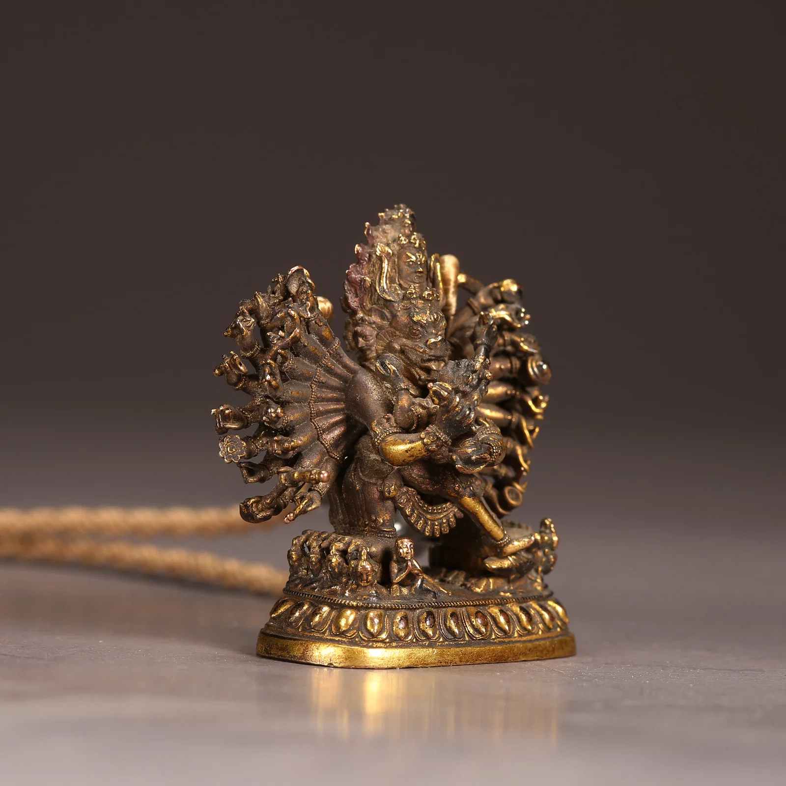 A GILT BRONZE SMALL SEATED MAHAVIRA VAJRA STATUE