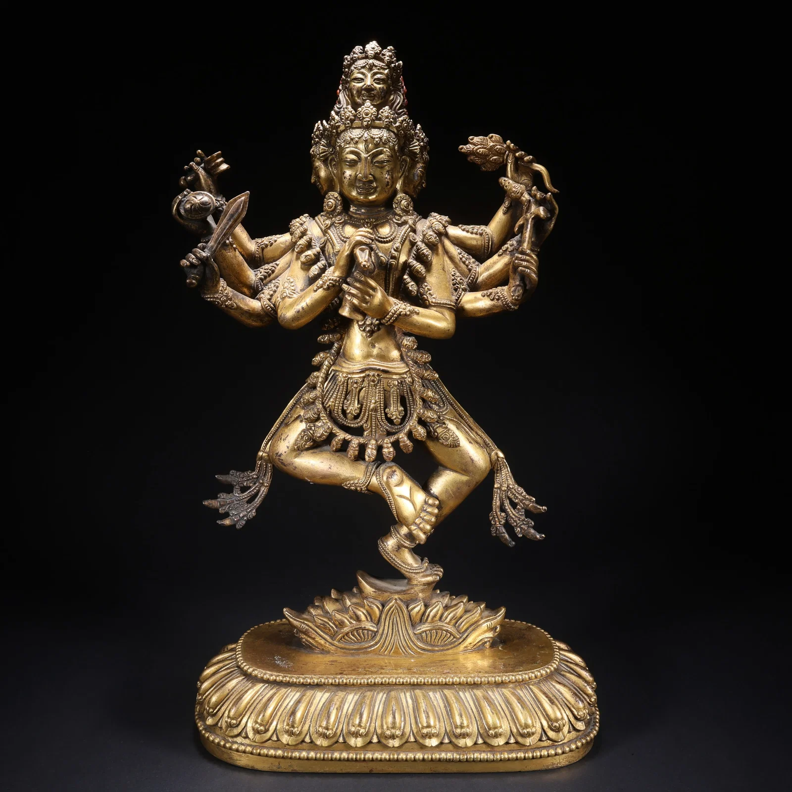 A GILT BRONZE STANDING EIGHT-ARMED THREE-FACED TARA