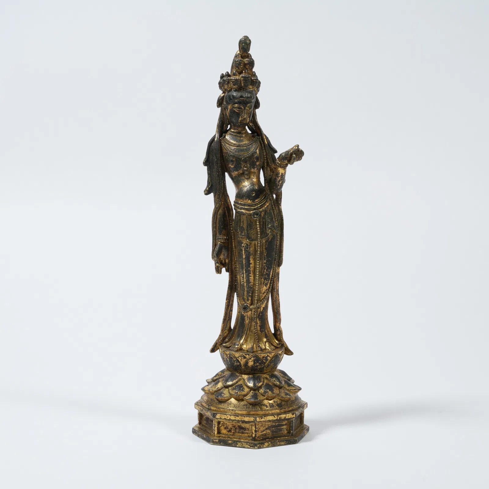 A GILT-BRONZE STANDING FIGURE OF ELEVEN-HEADED AVALOKITESHVARA