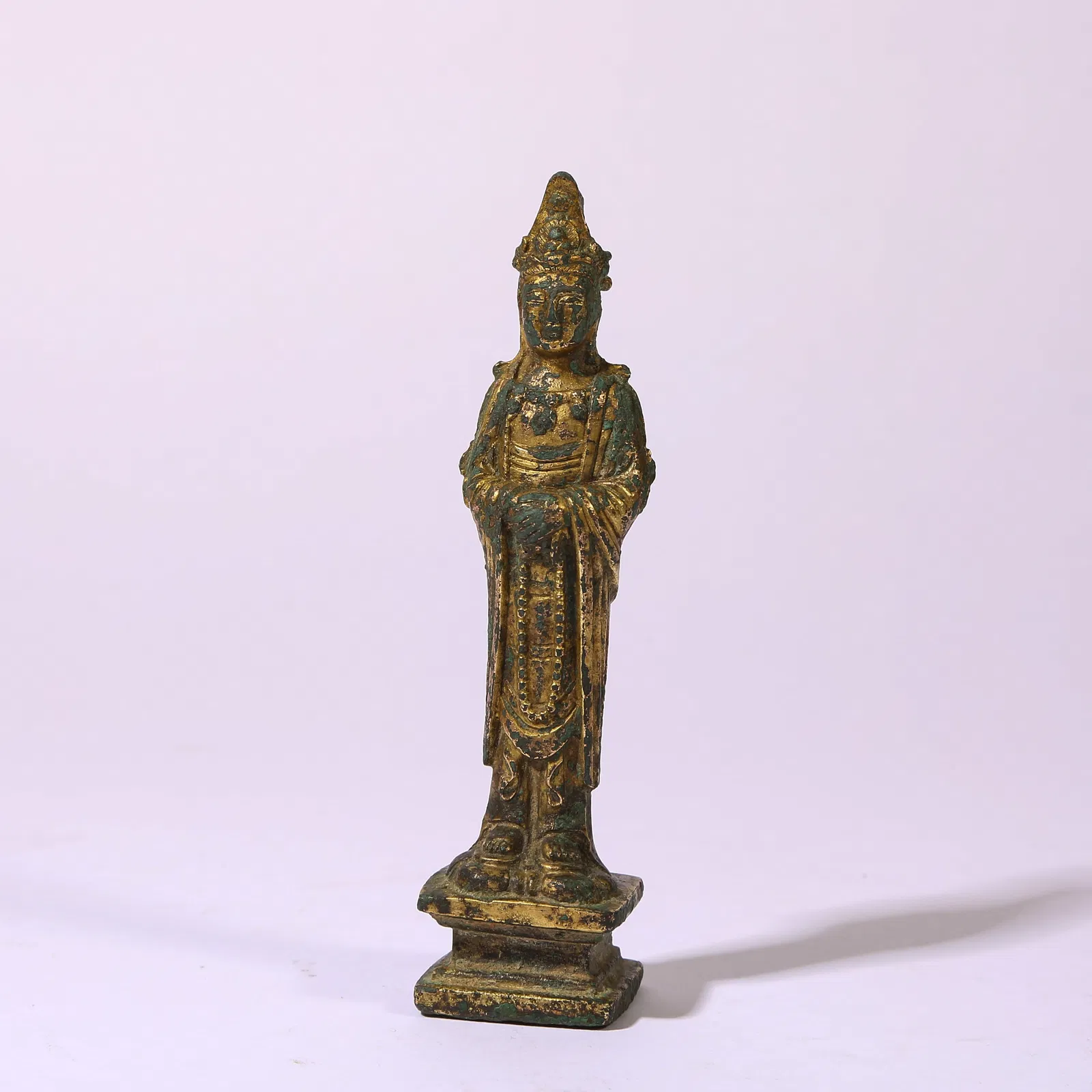 A GILT-BRONZE STANDING FIGURE OF GUANYIN