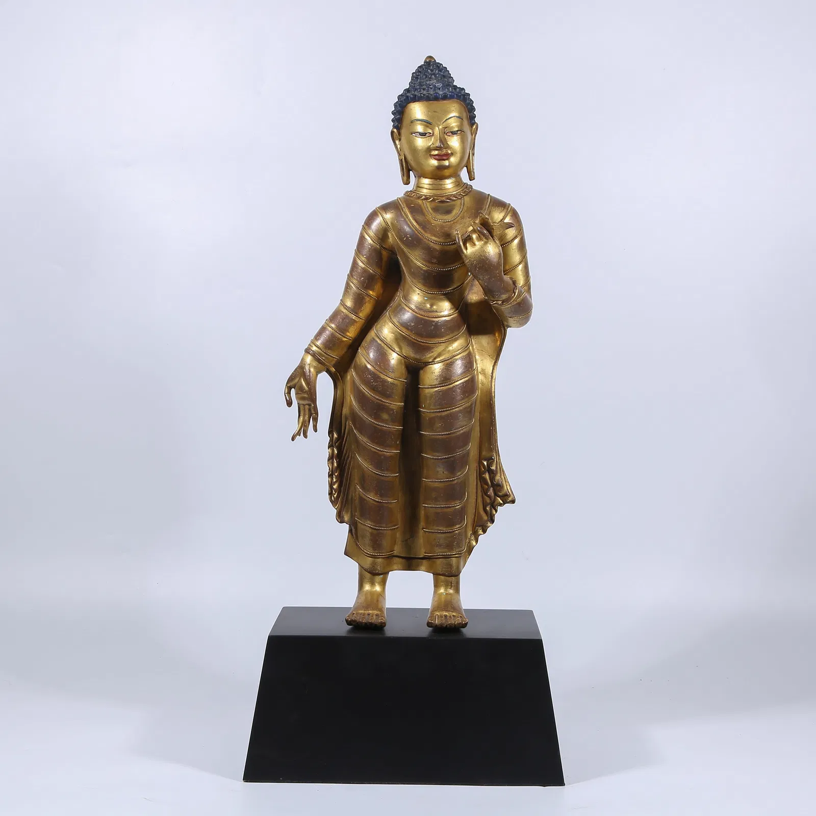 A GILT BRONZE STANDING SHAKYAMUNI BUDDHA STATUE