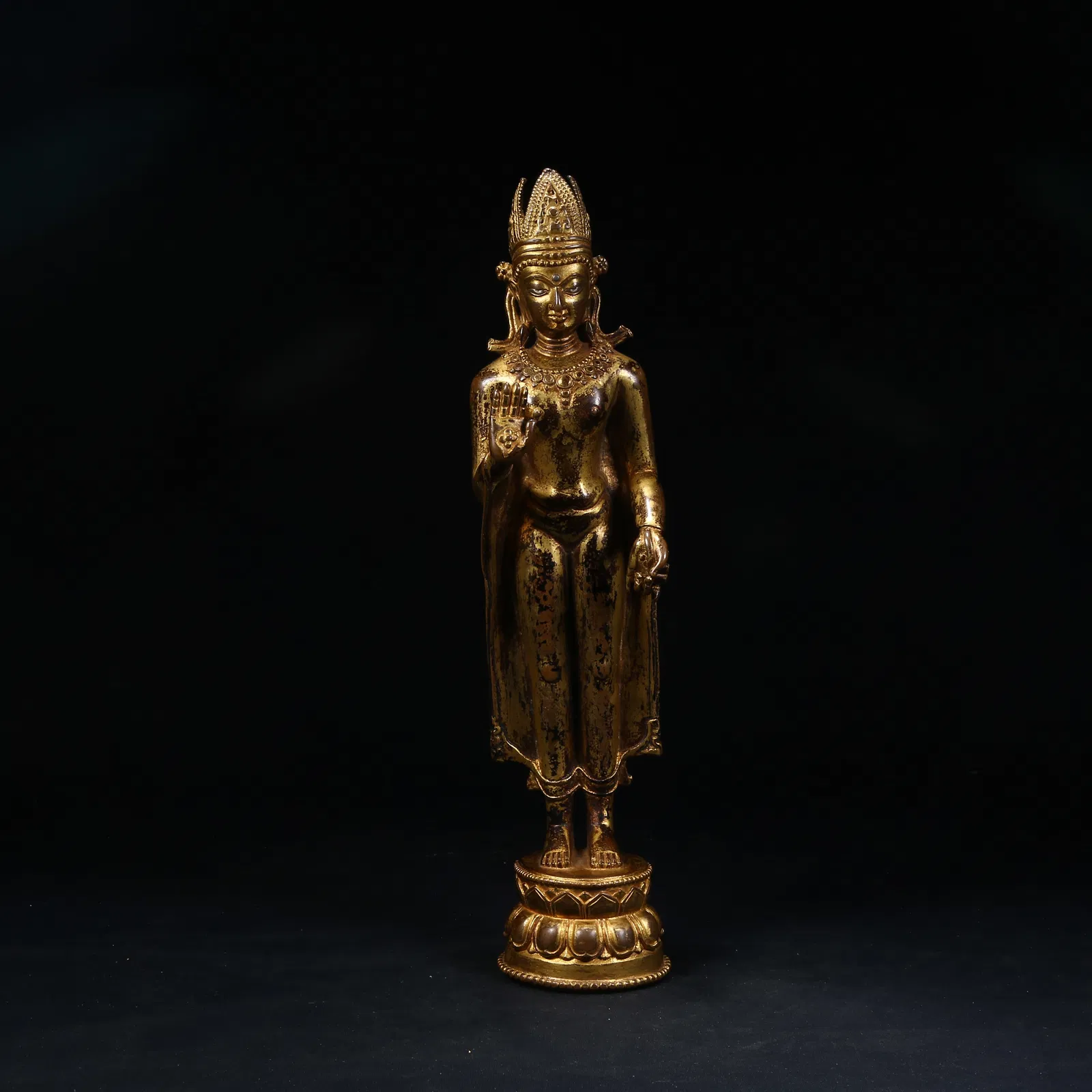 A GILT BRONZE STANDING SHAKYAMUNI BUDDHA