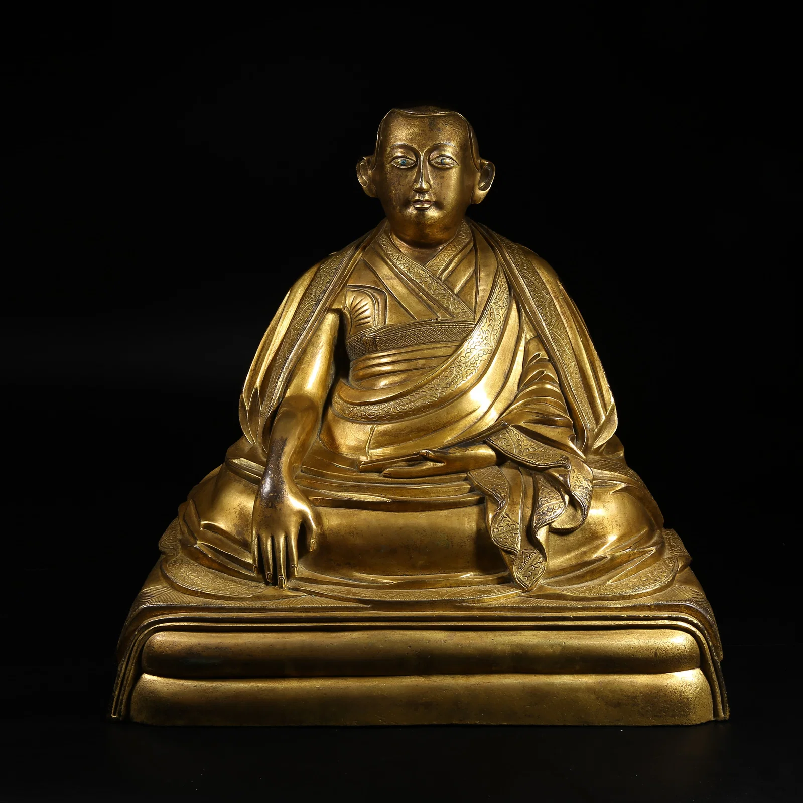 A GILT-BRONZE STATUE OF A LAMA