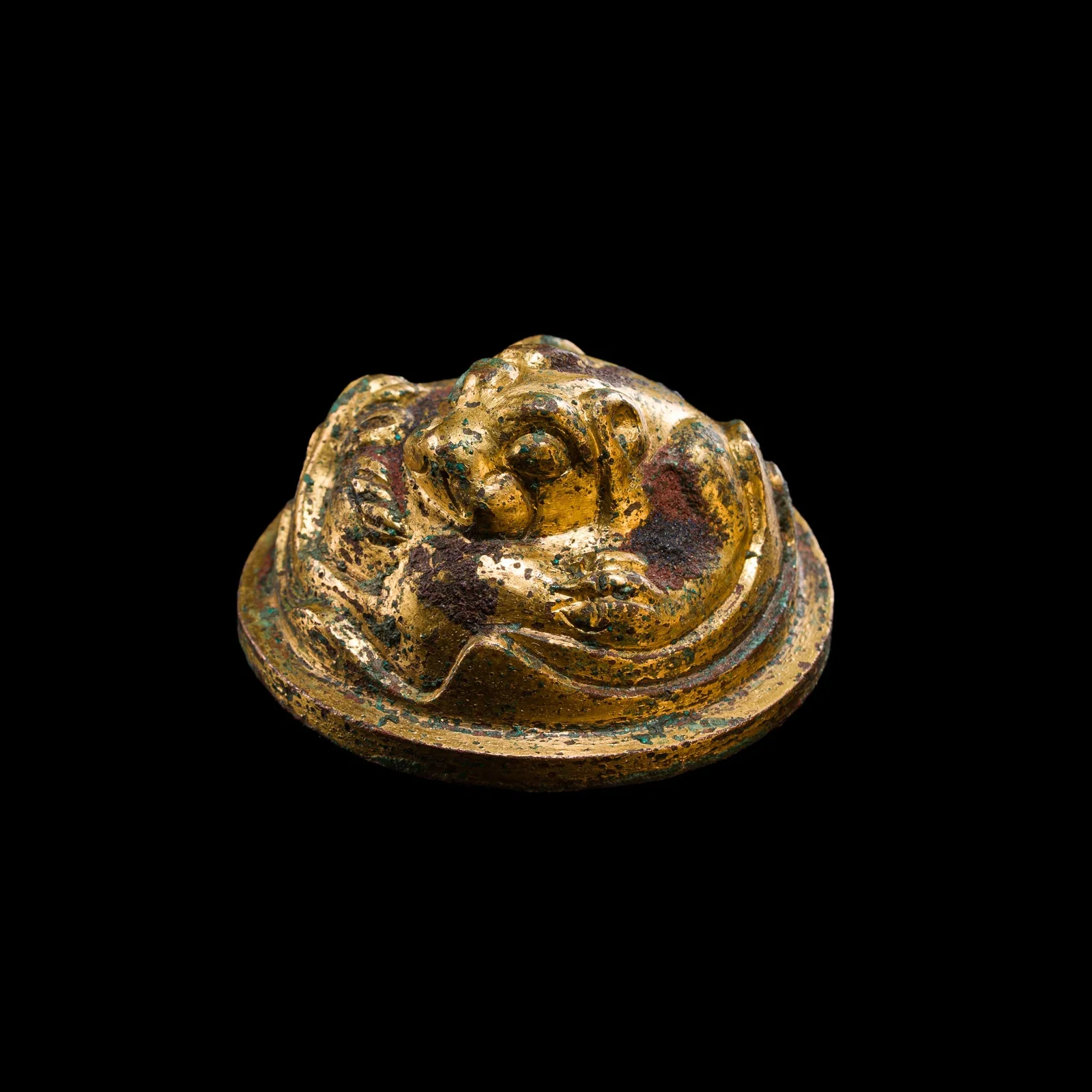 A GILT-BRONZE 'TIGER' MAT WEIGHT, HAN DYNASTY