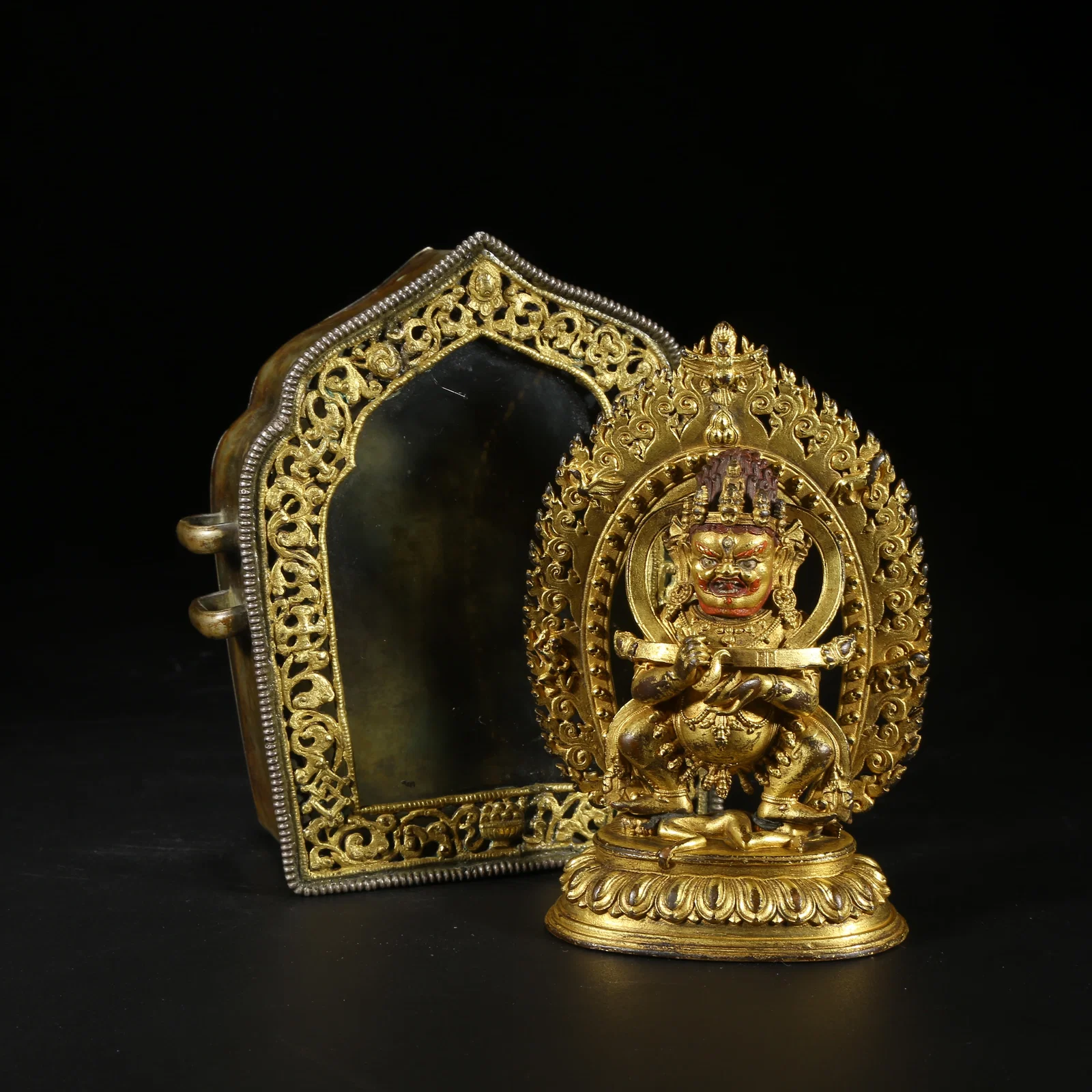 A GILT BRONZE TWO-ARMED MAH?K?LA WITH GAU BOX