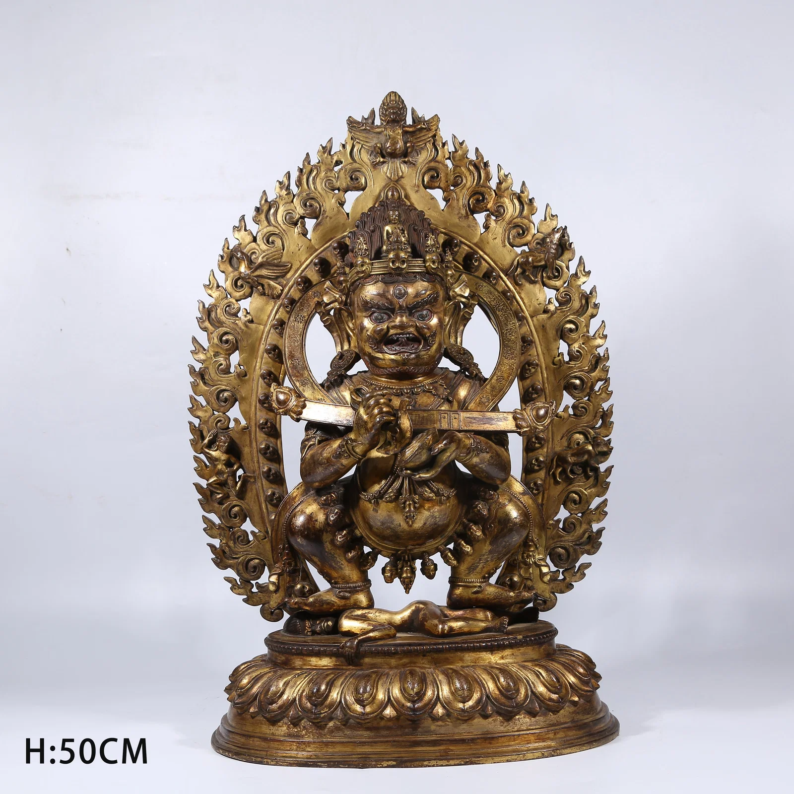 A GILT BRONZE TWO-ARMED MAHAKALA STATUE WITH CLUB