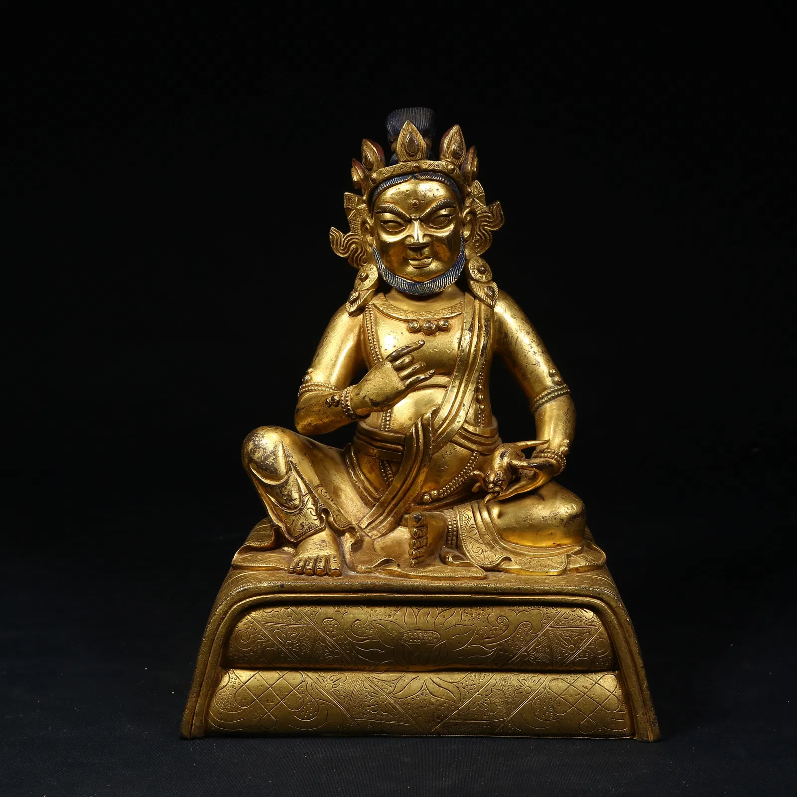 A GILT BRONZE WEALTH DEITY STATUE