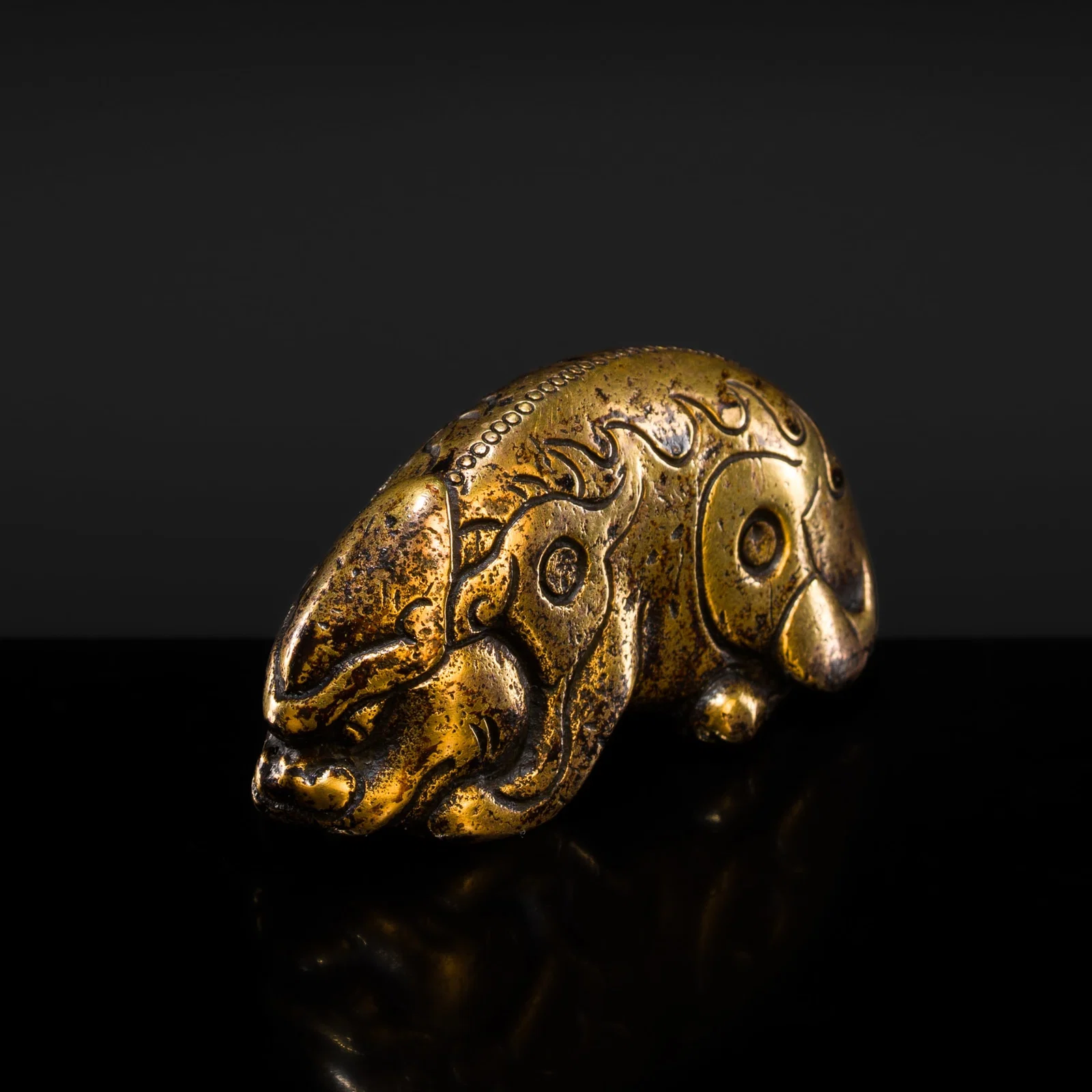 A GILT-BRONZE 'XINIU' WEIGHT, MING DYNASTY