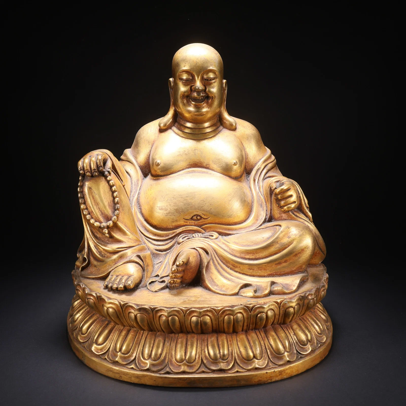 A GILT-COPPER BUDAI (LAUGHING MONK) FIGURE