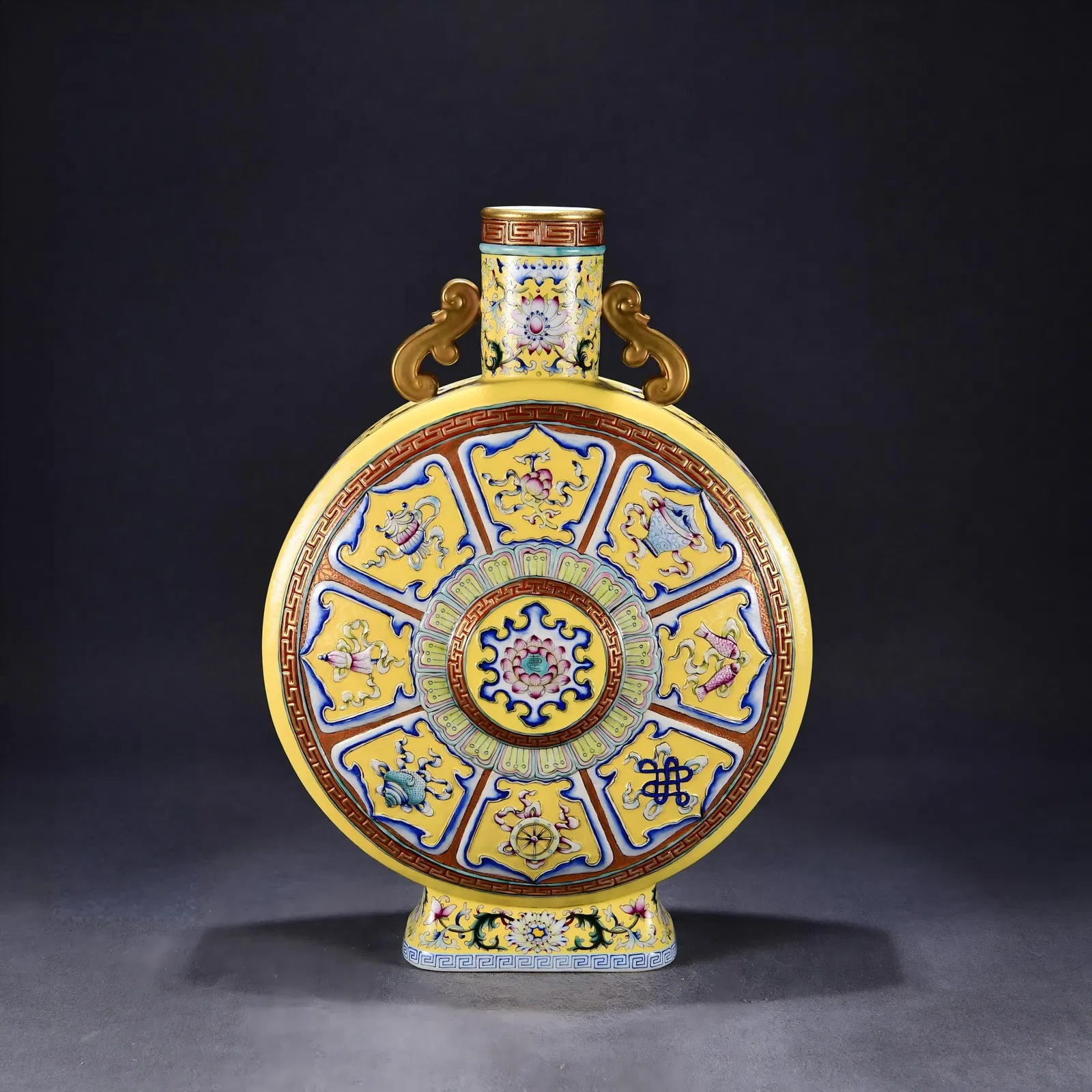 A gilt flat bottle with famille rose enamels and carved eight auspicious symbols from the Qianlong