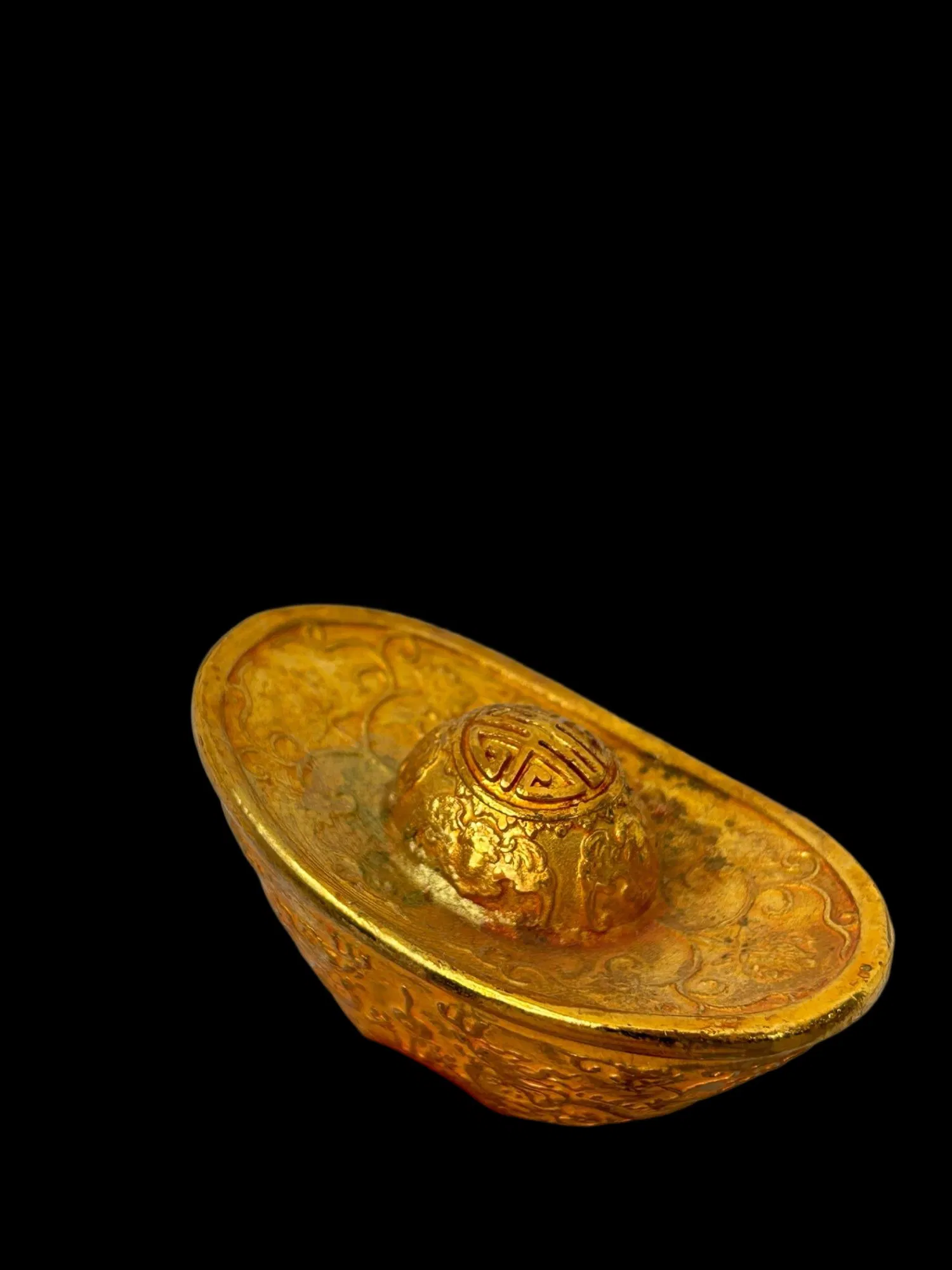 A gilt gold ingot with a double dragon playing with a pearl design and Qianlong reign mark.