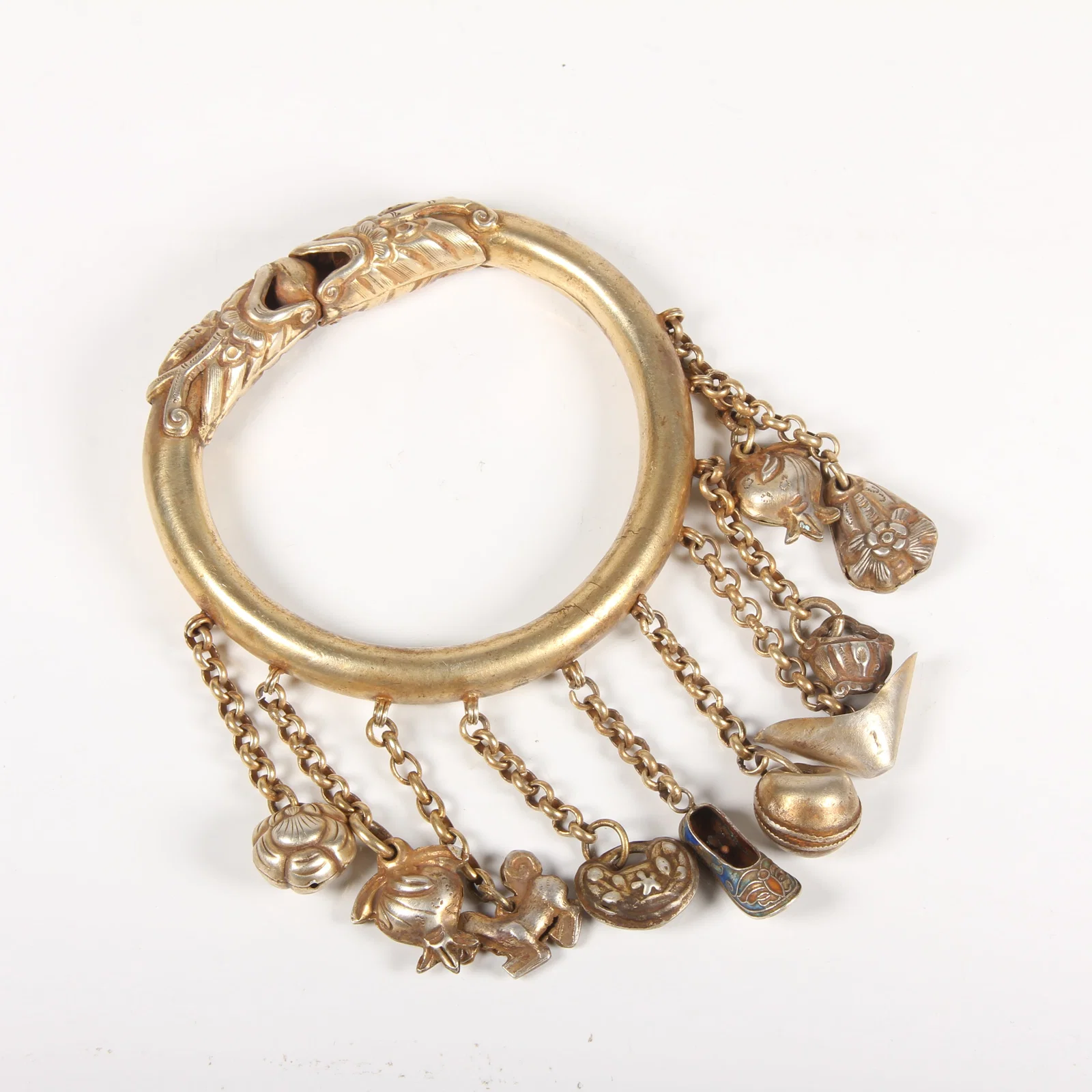 A GILT-SILVER BRACELET WITH DOUBLE DRAGON CHASING PEARL MOTIF