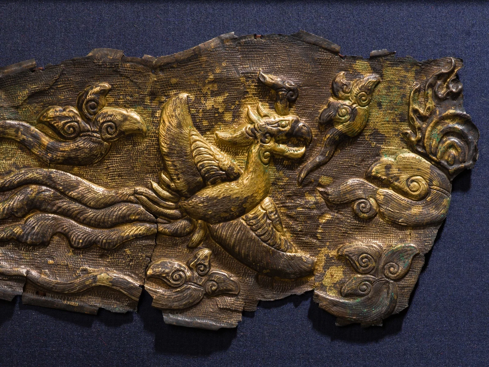 A GILT-SILVER REPOUSSÉ 'PHOENIX' FRAGMENT, LIAO DYNASTY