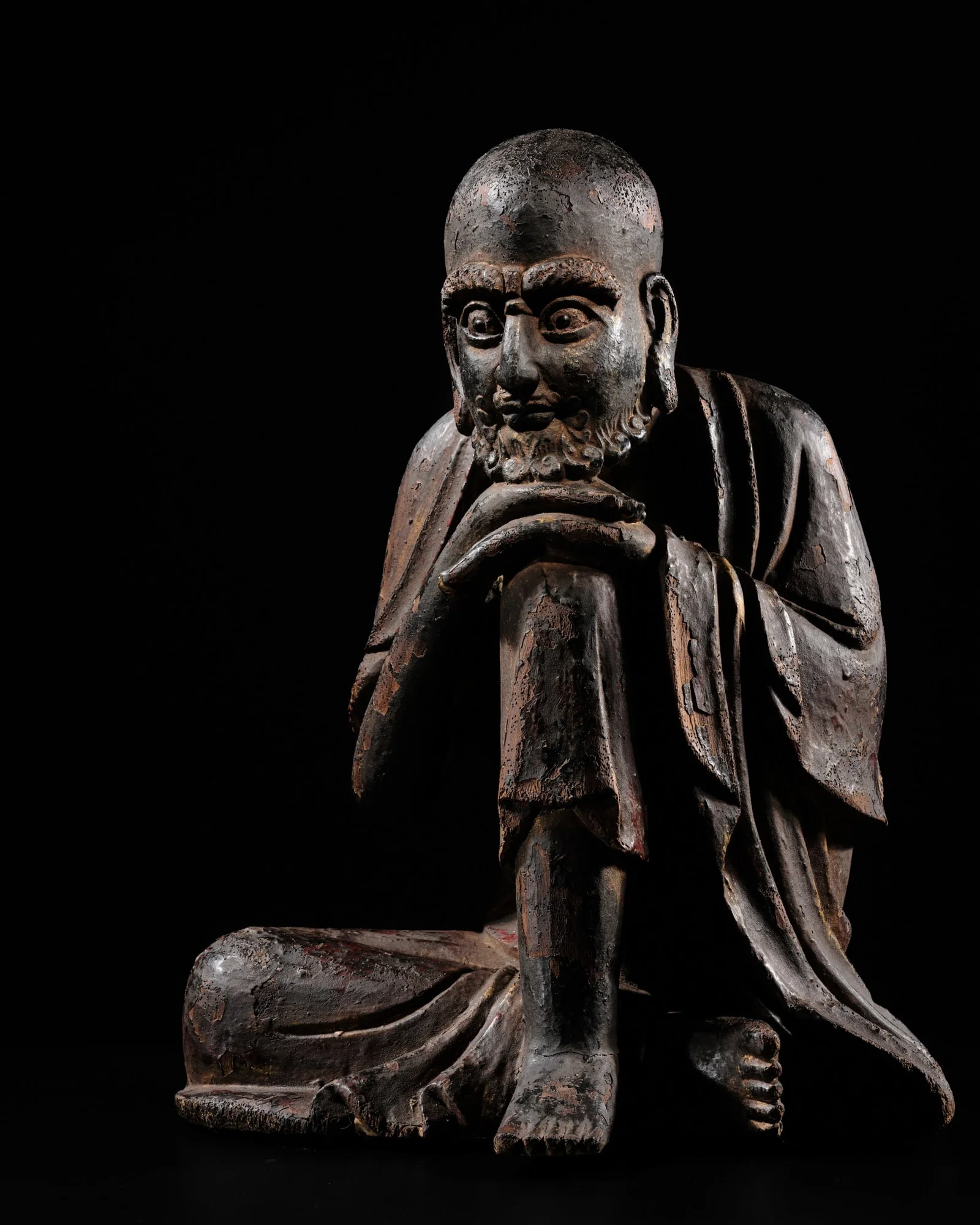 A GLASS-INLAID AND LACQUERED WOOD FIGURE OF BUDDHA SHAKYAMUNI AS AN ASCETIC, YUAN DYNASTY