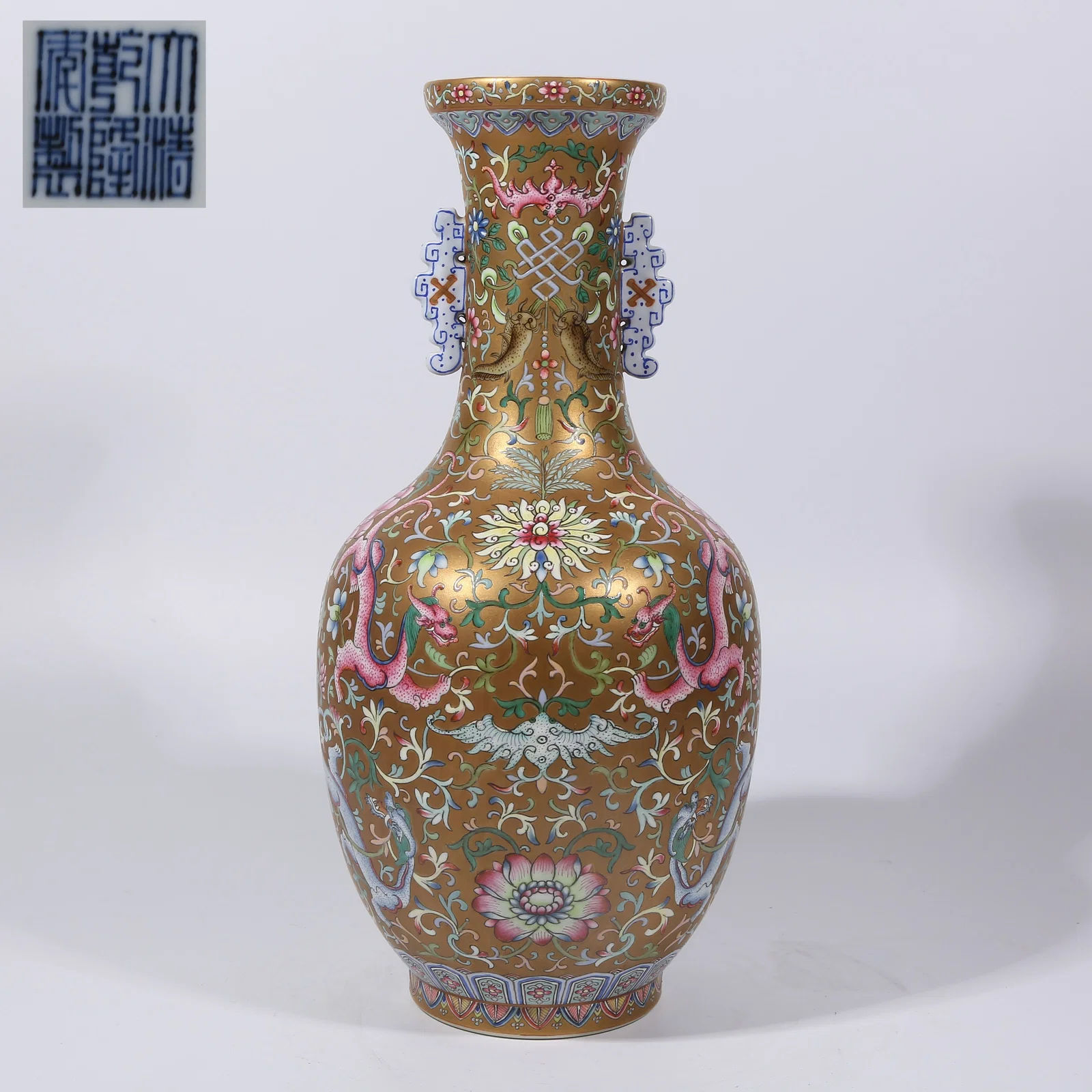 A GOLD-GROUND FAMILLE ROSE DRAGON THROUGH-FLOWER DOUBLE-HANDLED MOUTH-RIM VASE