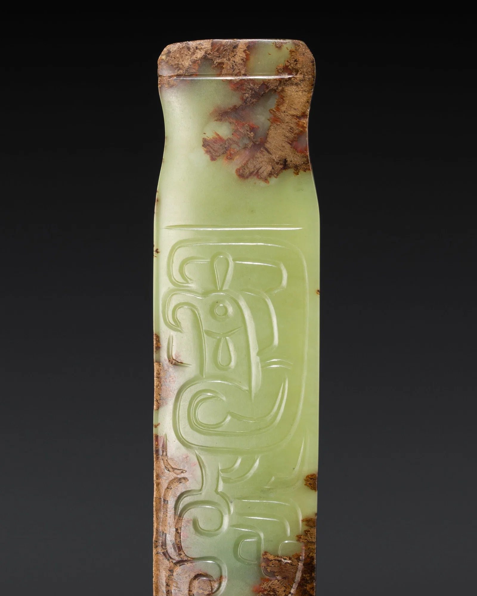 A GREEN AND RUSSET JADE 'PHOENIX AND DRAGON' PENDANT, WESTERN ZHOU DYNASTY