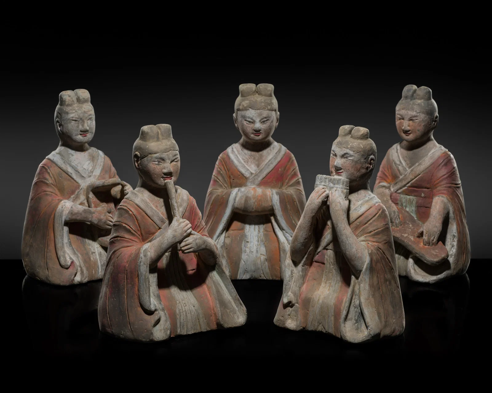 A GROUP OF FIVE PAINTED GRAY POTTERY FIGURES OF FEMALE MUSICIANS, HAN DYNASTY