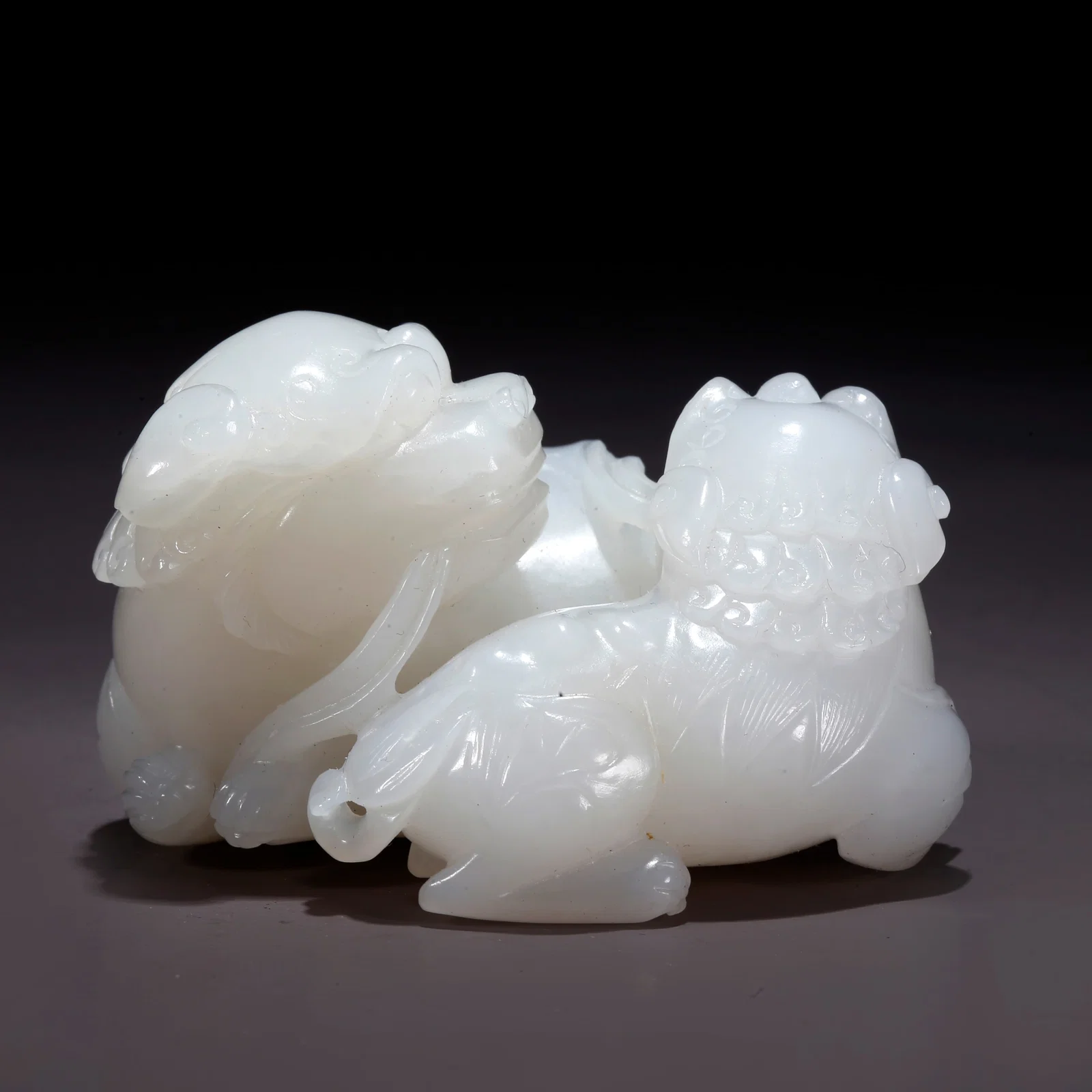 A HETIAN JADE ADULT AND CUB LION FIGURINE