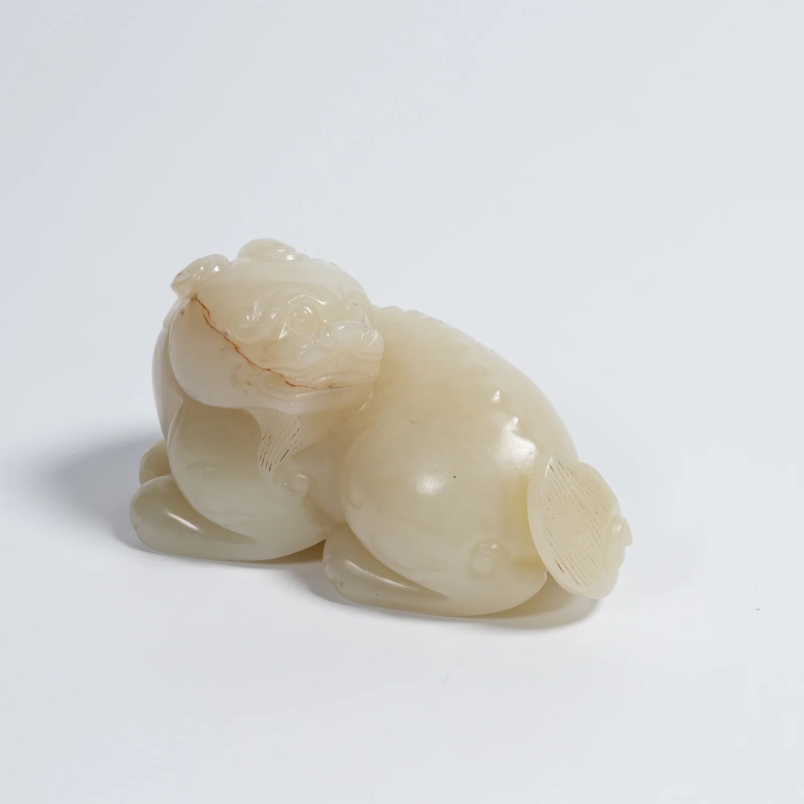 A HETIAN JADE AUSPICIOUS BEAST ORNAMENT