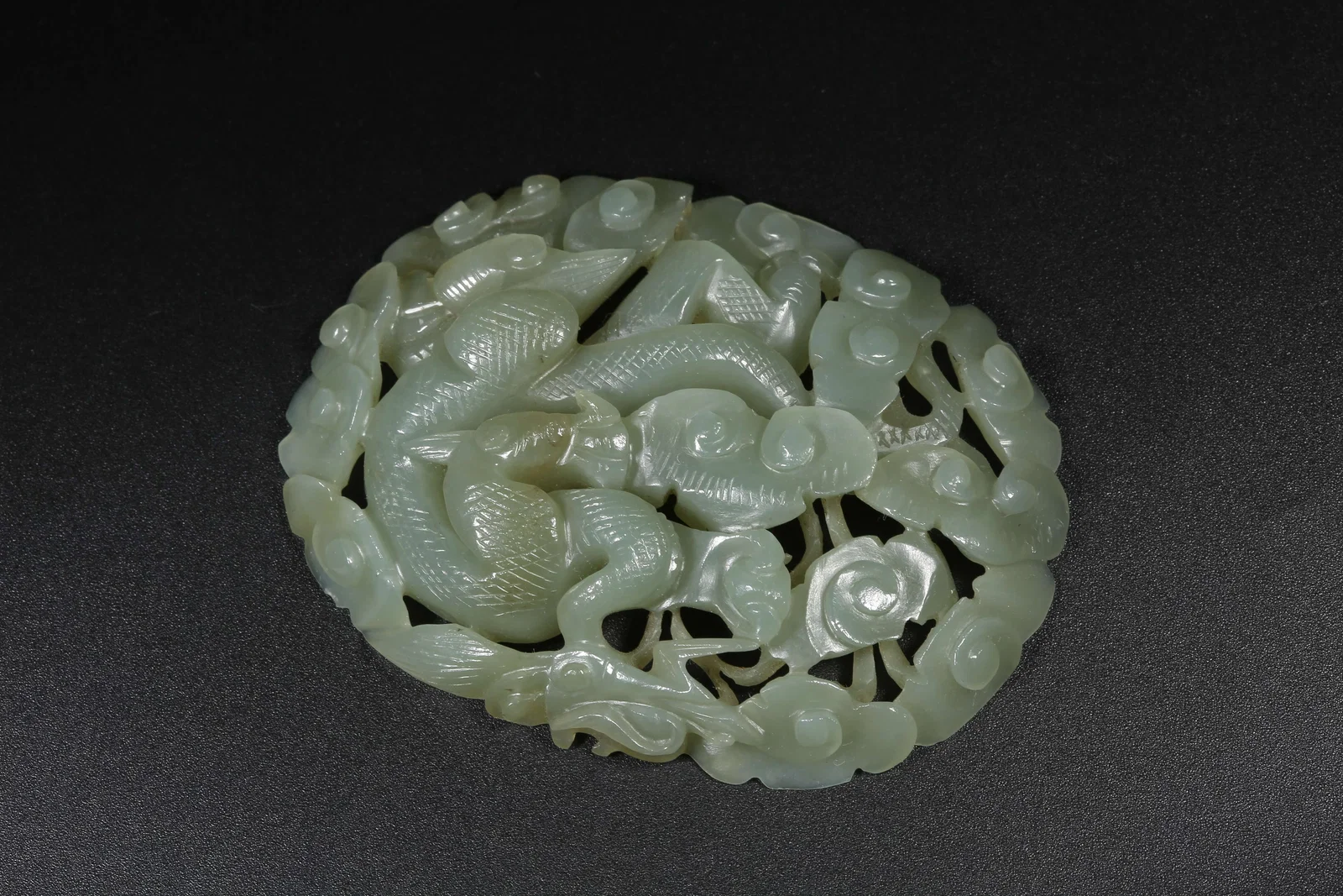 A HETIAN JADE BELT ORNAMENT WITH CLOUD AND DRAGON MOTIF
