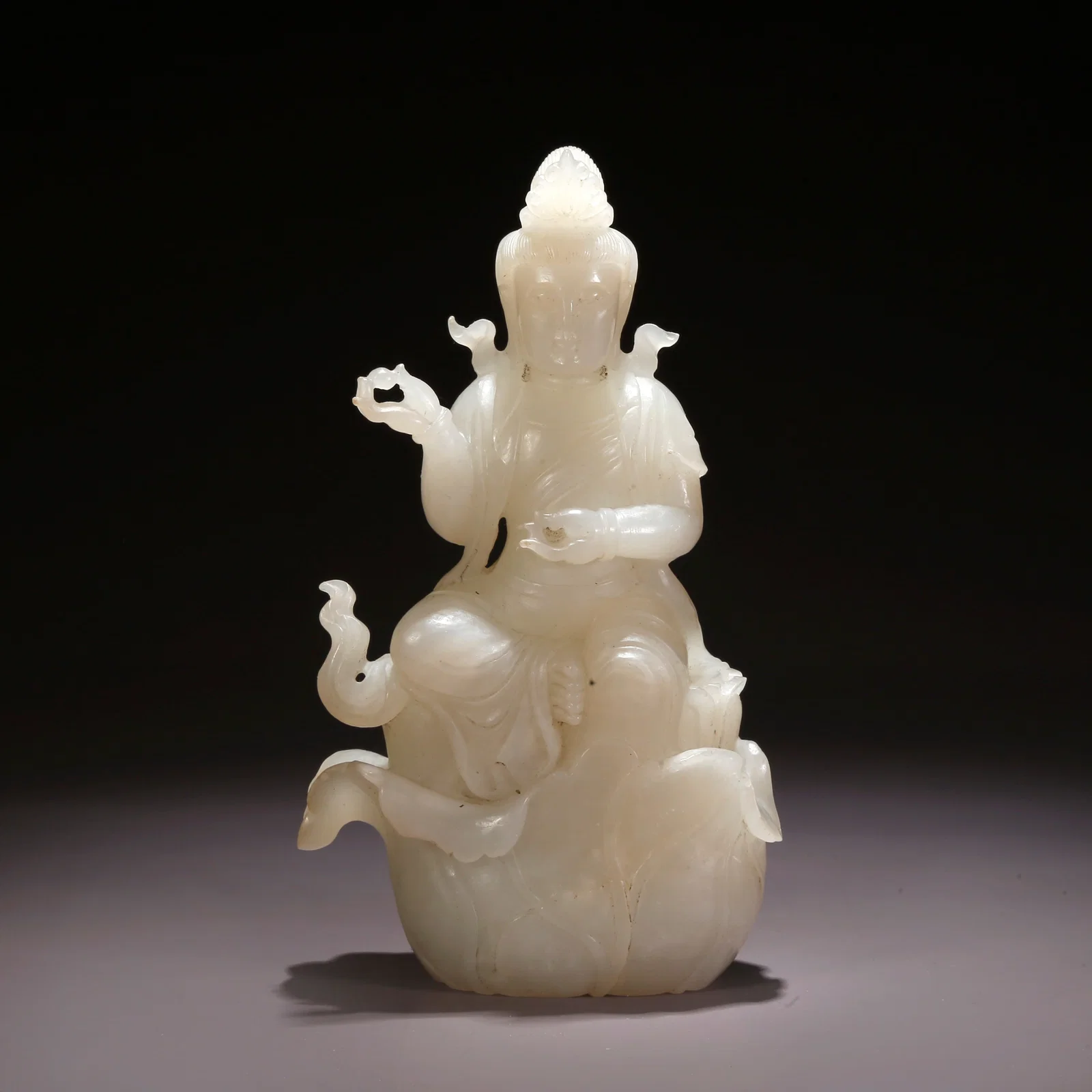 A HETIAN JADE BUDDHA FIGURE