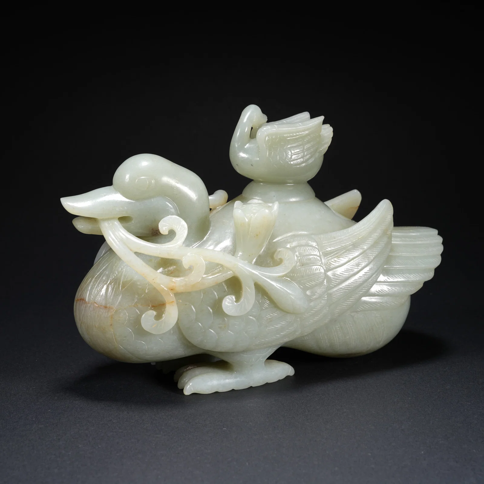 A HETIAN JADE CARVED BIRD-FORM FIGURE
