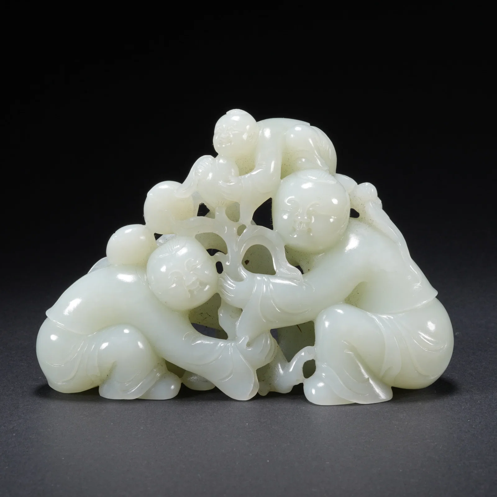 A HETIAN JADE CARVED BOY-FORM FIGURE