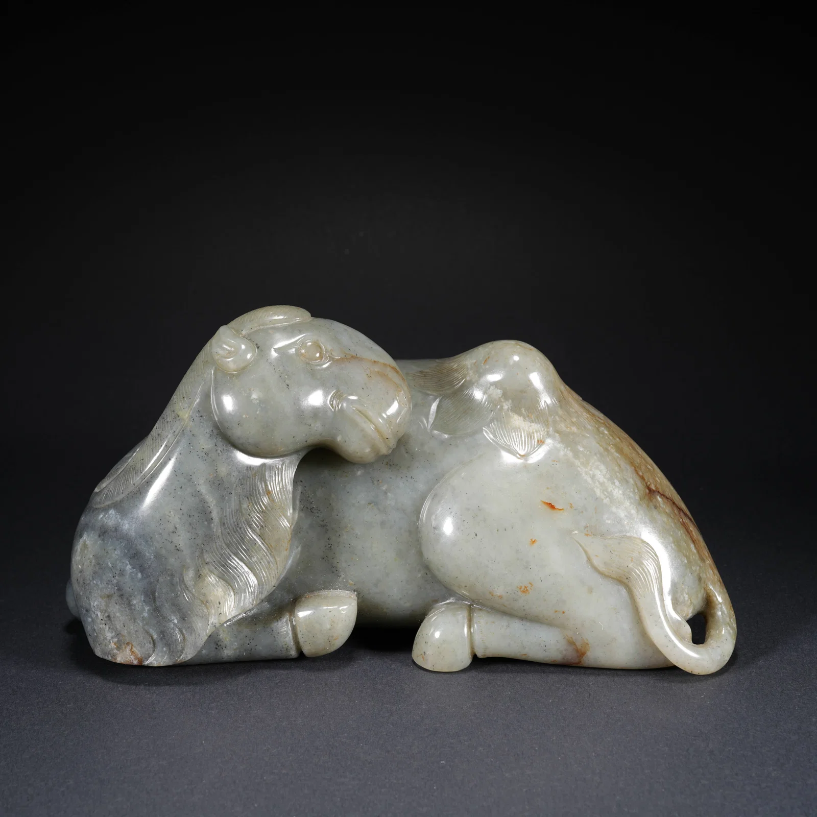 A HETIAN JADE CARVED CAMEL-FORM FIGURE