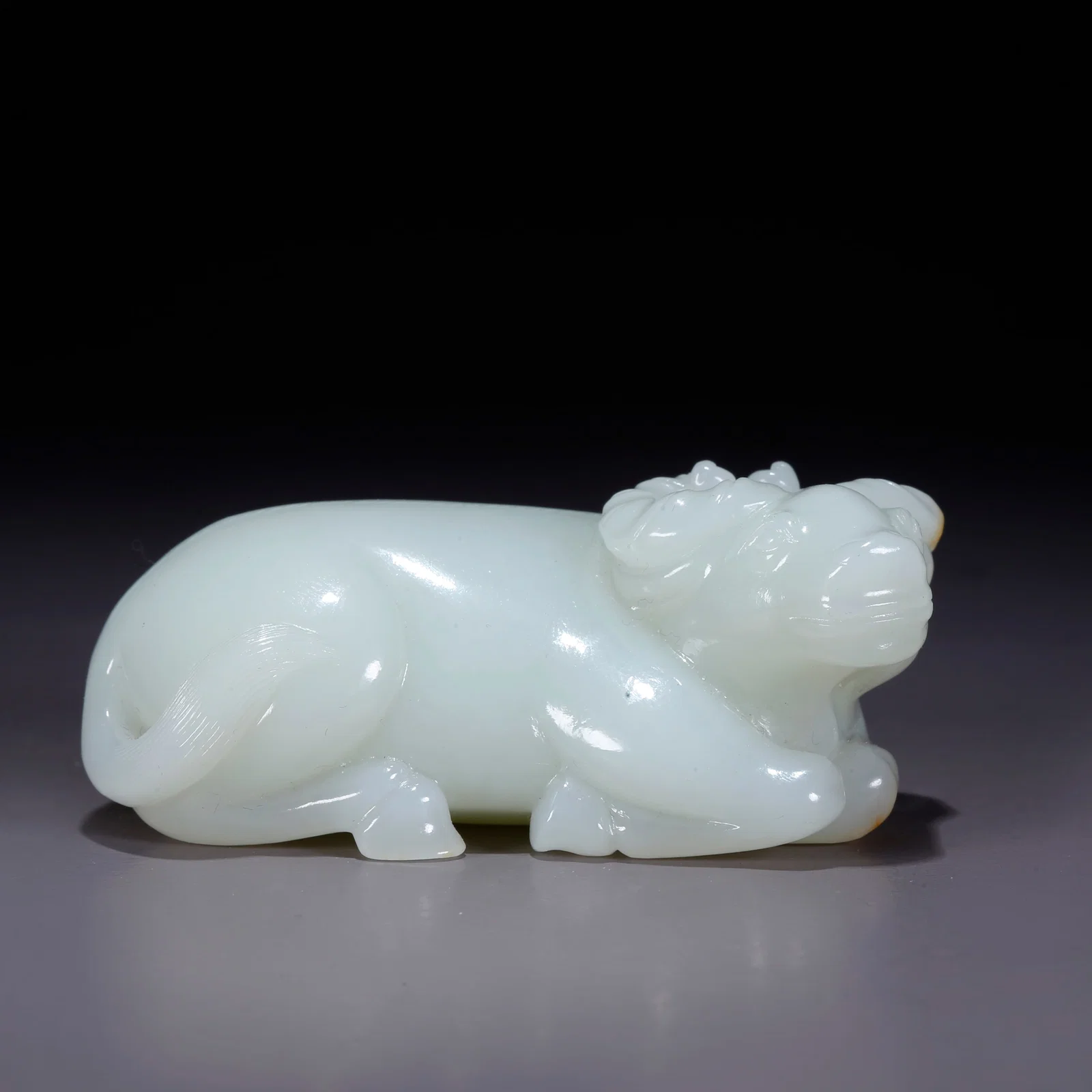 A HETIAN JADE CARVED COW ORNAMENT