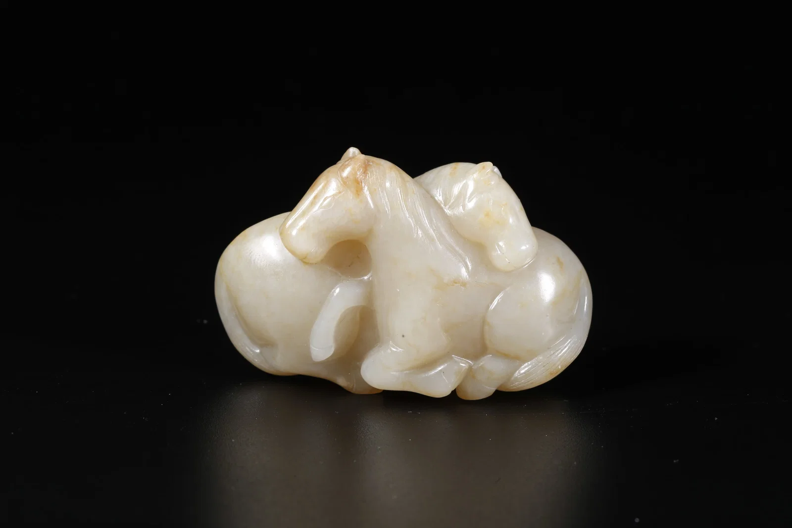 A HETIAN JADE CARVED DOUBLE HORSE ORNAMENT
