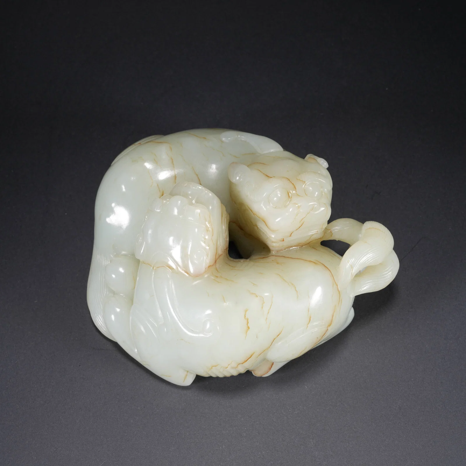 A HETIAN JADE CARVED DOUBLE-LION FIGURE