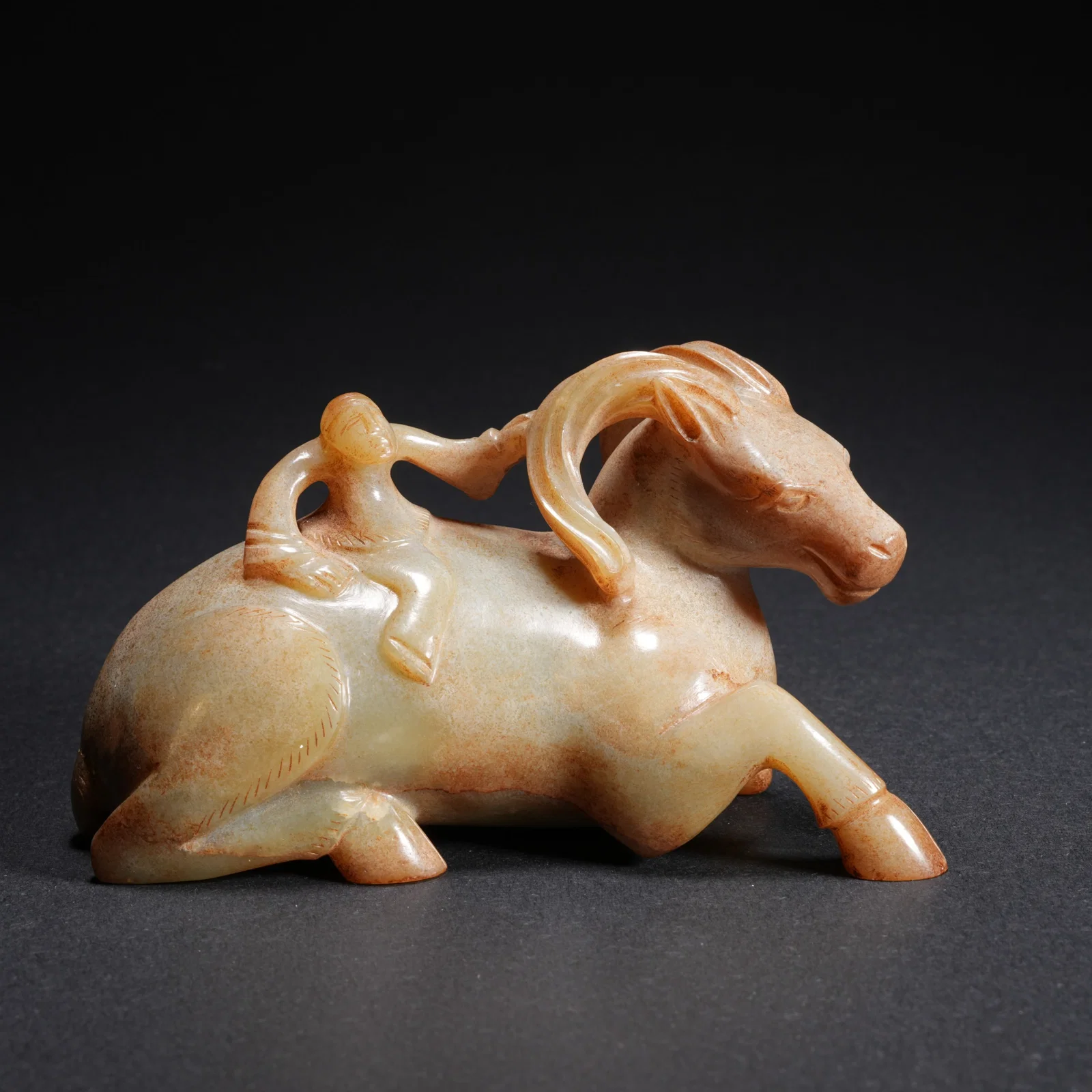 A HETIAN JADE CARVED FIGURE RIDING ANIMAL