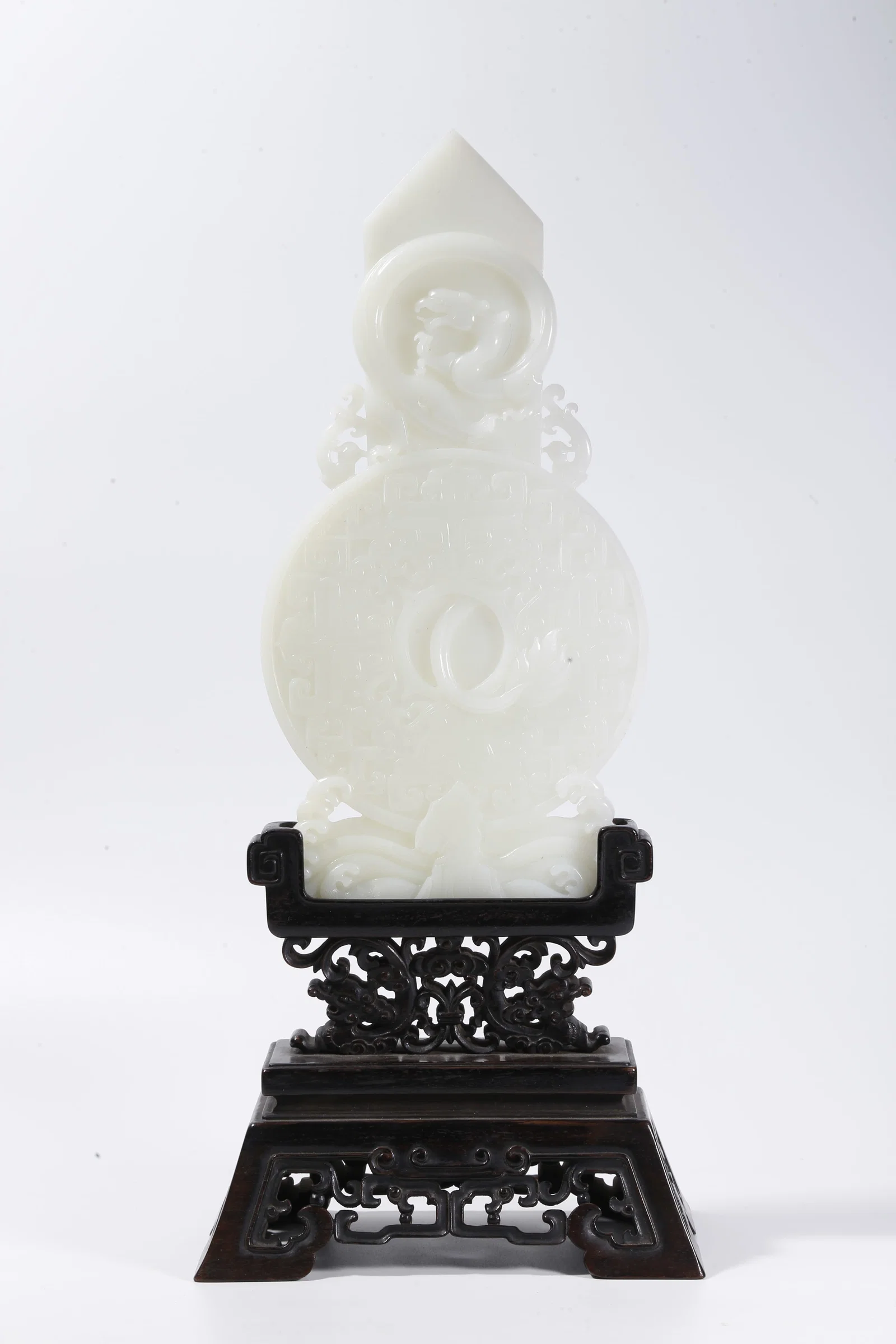 A HETIAN JADE CARVED GUI-BI WITH BEAST MASK AND DRAGON MOTIF
