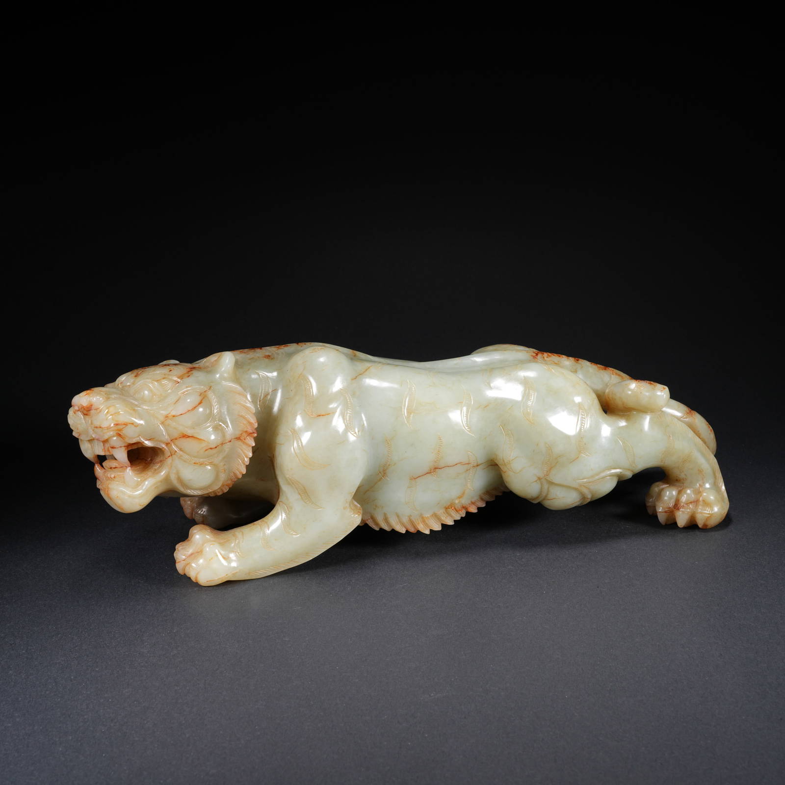 A HETIAN JADE CARVED TIGER FIGURE