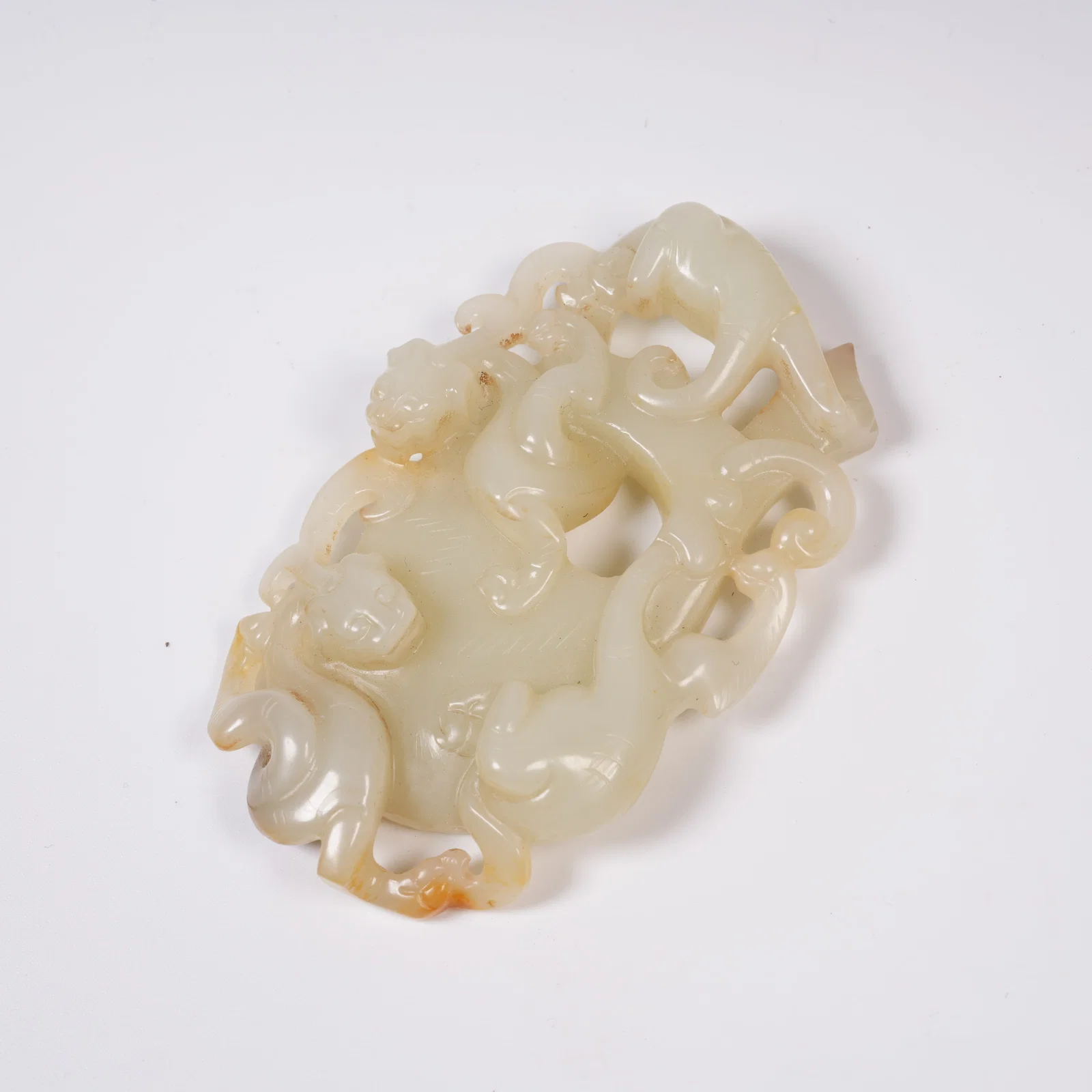 A HETIAN JADE CHICKEN-HEART PENDANT WITH CHI DRAGON MOTIF
