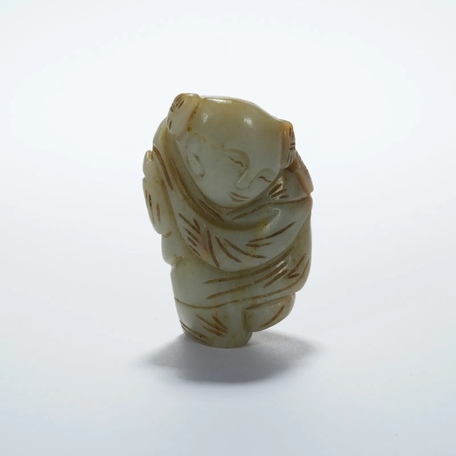 A HETIAN JADE CHILD-SHAPED PENDANT
