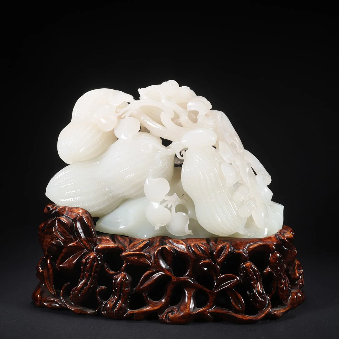 A HETIAN JADE "CONTINUOUS GROWTH OF MELONS" ORNAMENT
