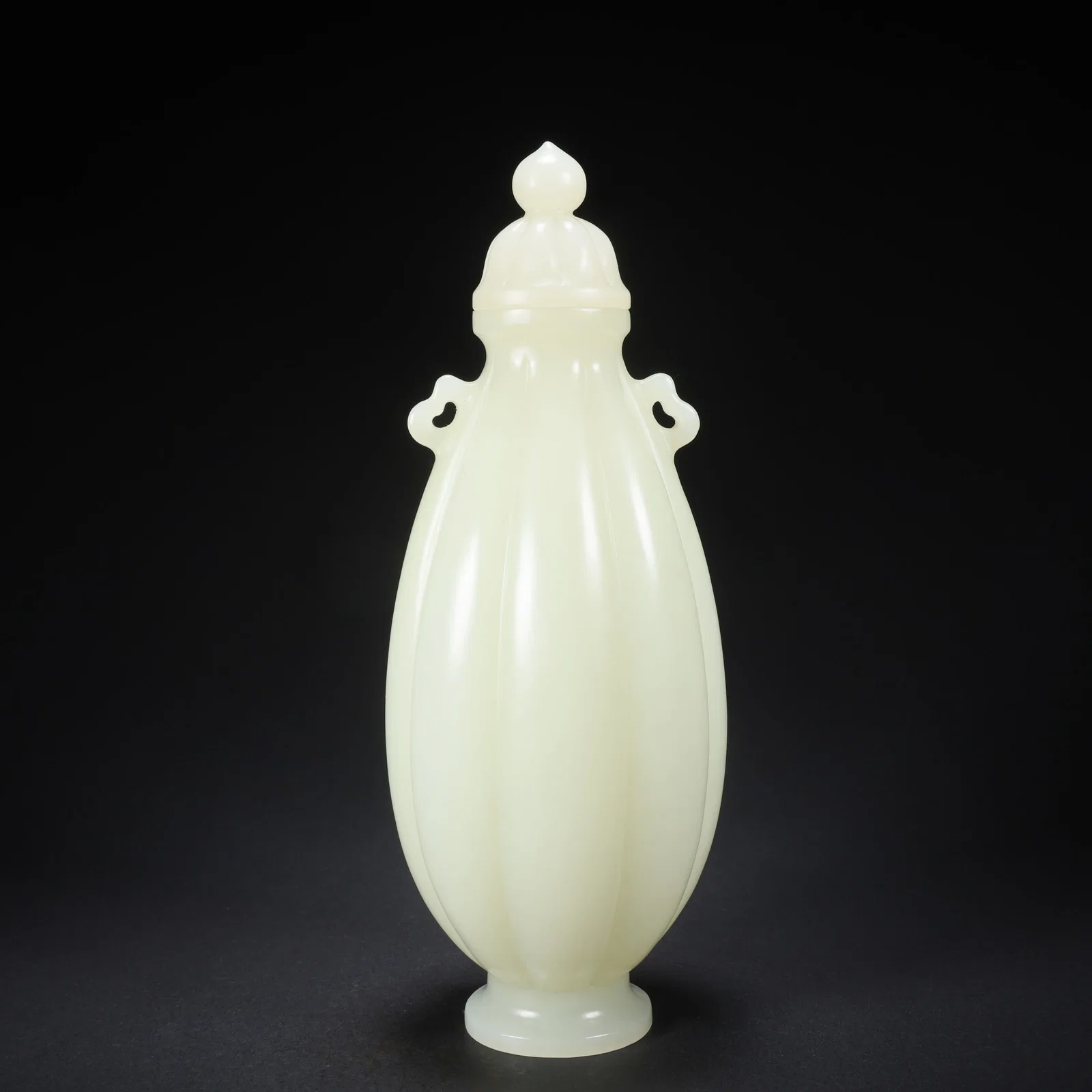 A HETIAN JADE DOUBLE-HANDLED MELON-LOBED COVERED VASE