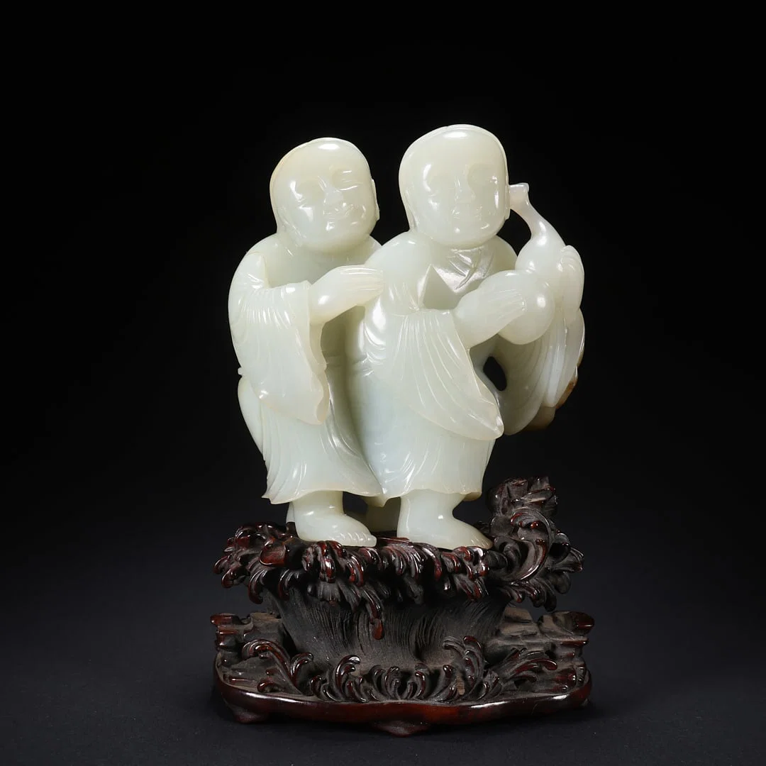 A HETIAN JADE "HEHE ERXIAN" (IMMORTALS OF HARMONY) ON WOODEN BASE