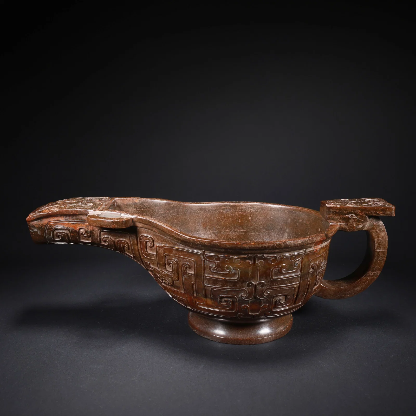 A HETIAN JADE LARGE HORN CUP WITH BEAST FACES
