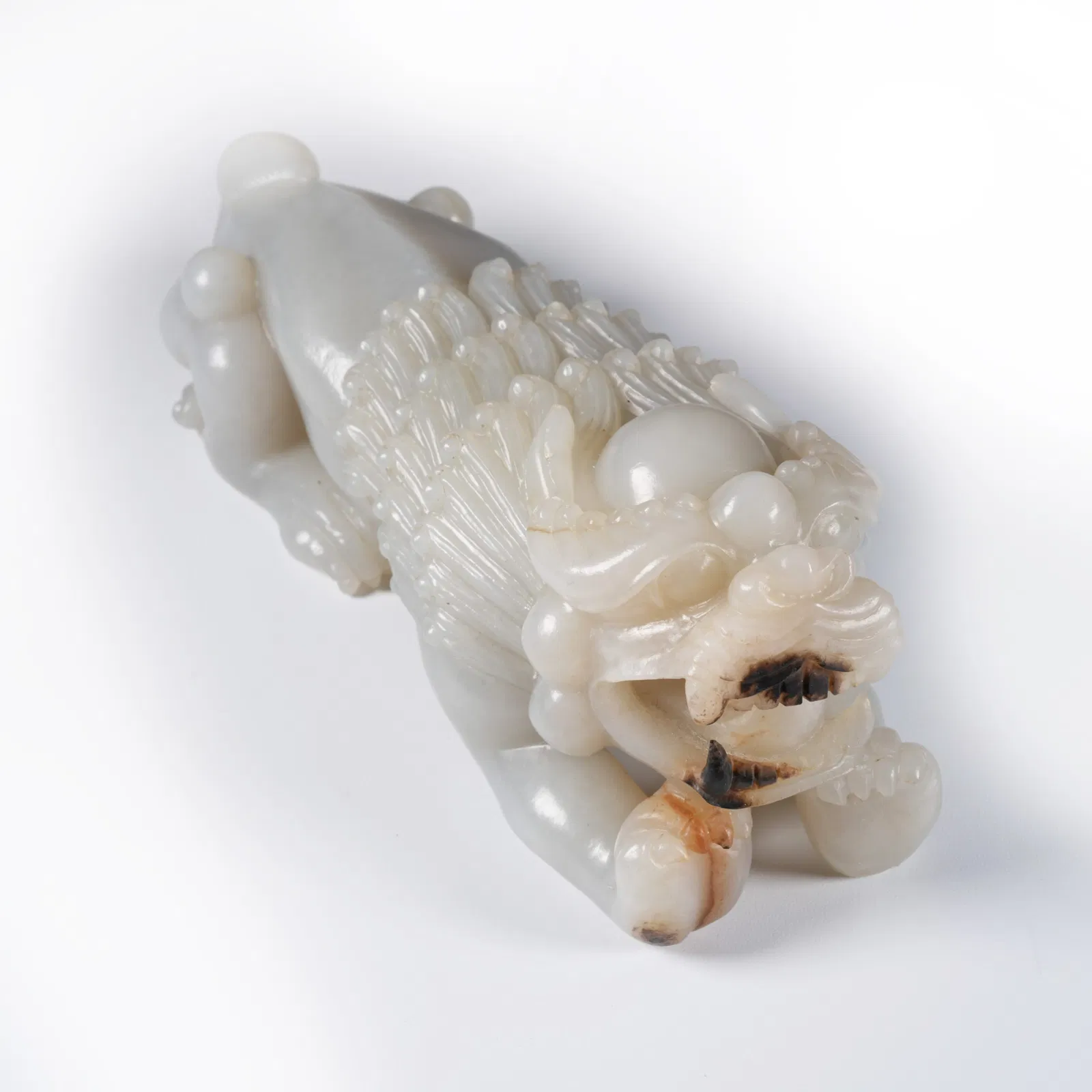 A HETIAN JADE LION ORNAMENT