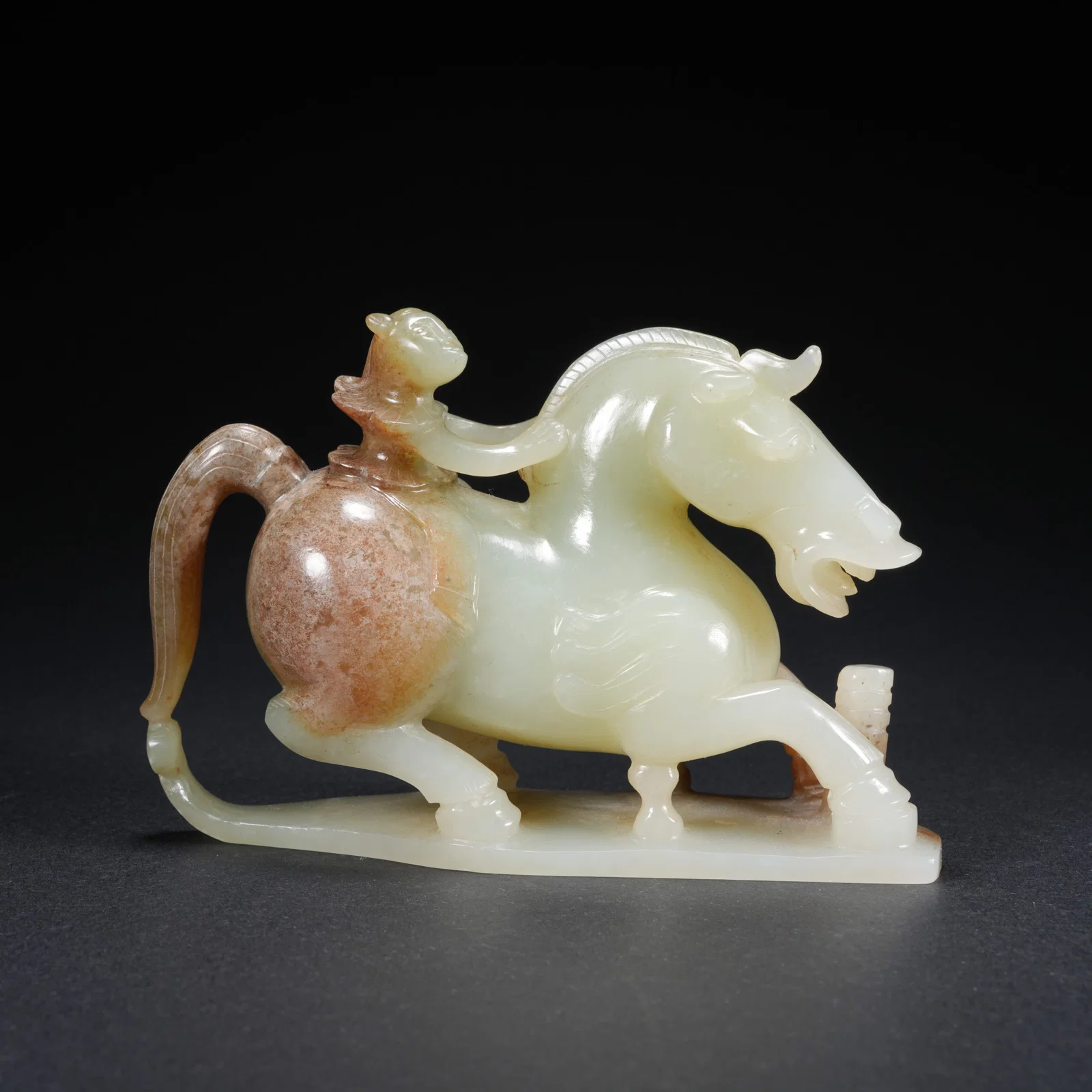 A HETIAN JADE MAN-AND-HORSE ORNAMENT