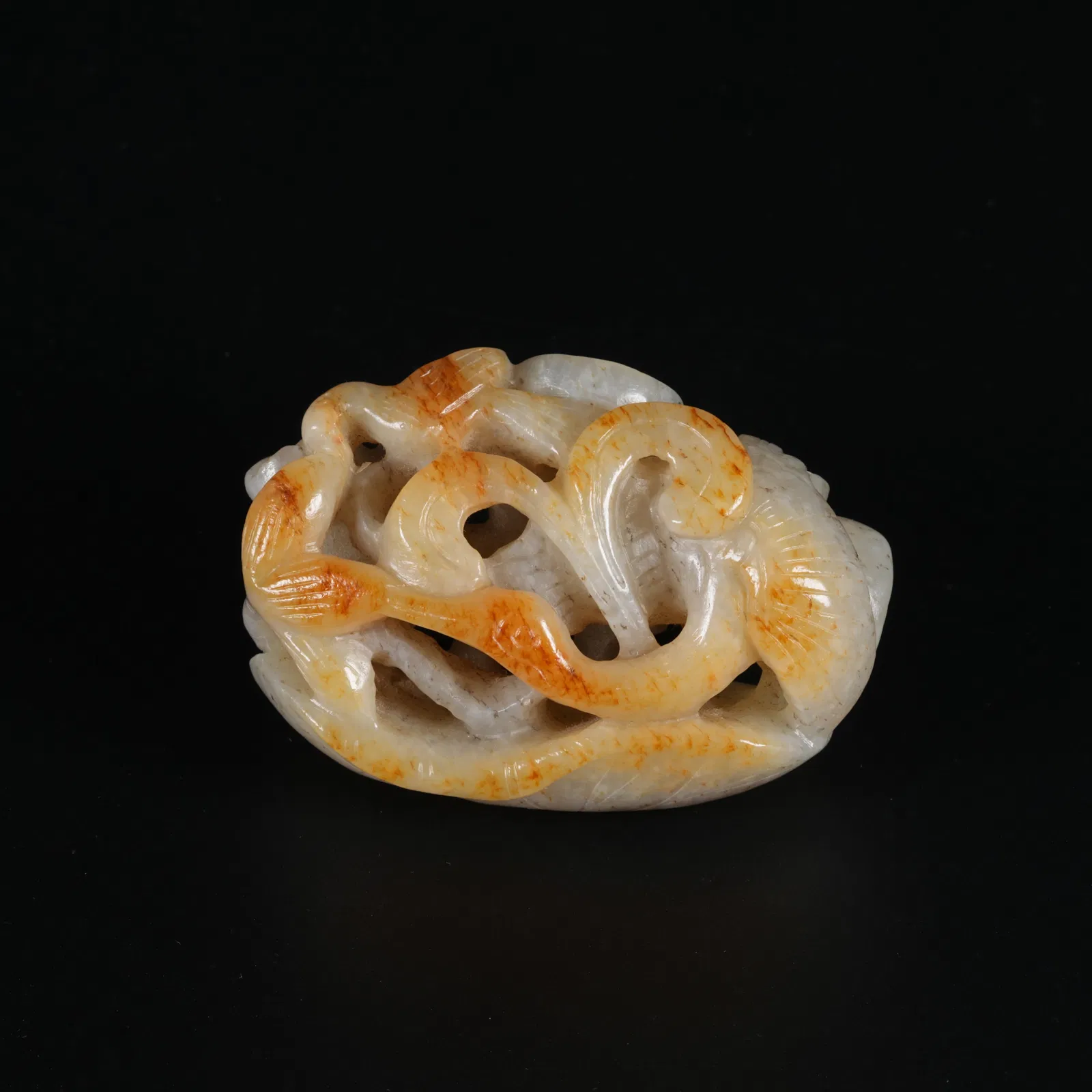 A HETIAN JADE PENDANT WITH LOTUS LEAF MOTIF