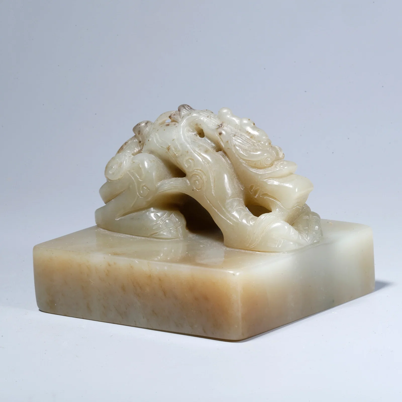A HETIAN JADE SEAL WITH RECLINING DRAGON KNOB