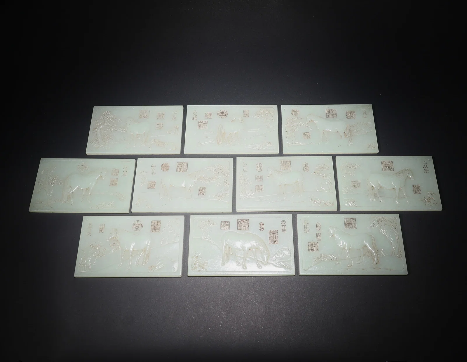 A HETIAN JADE SET OF TEN JADE TABLETS CARVED WITH POETRY AND HORSES