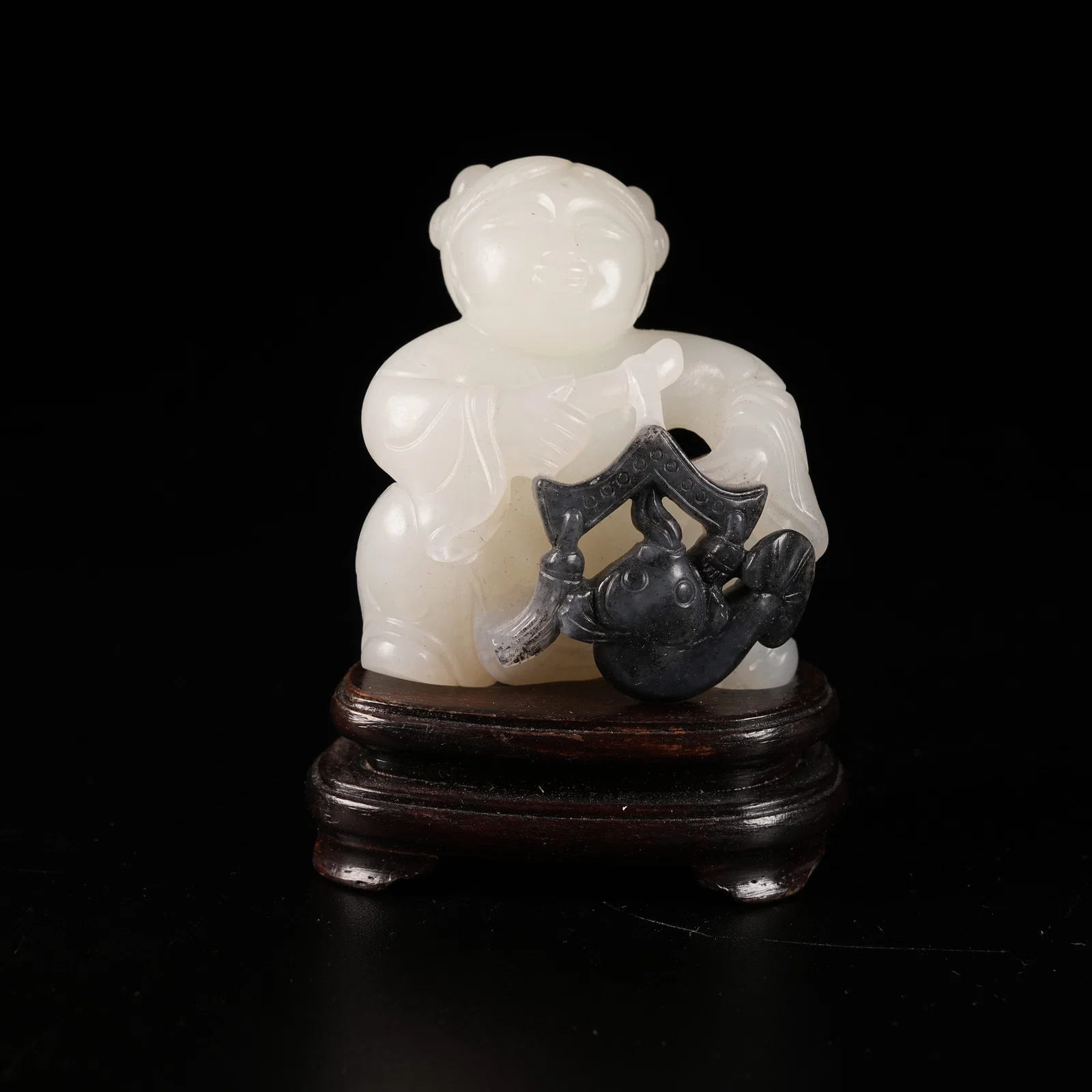 A HETIAN JADE SKILLFULLY CARVED PLAYING-FISH BOY ORNAMENT