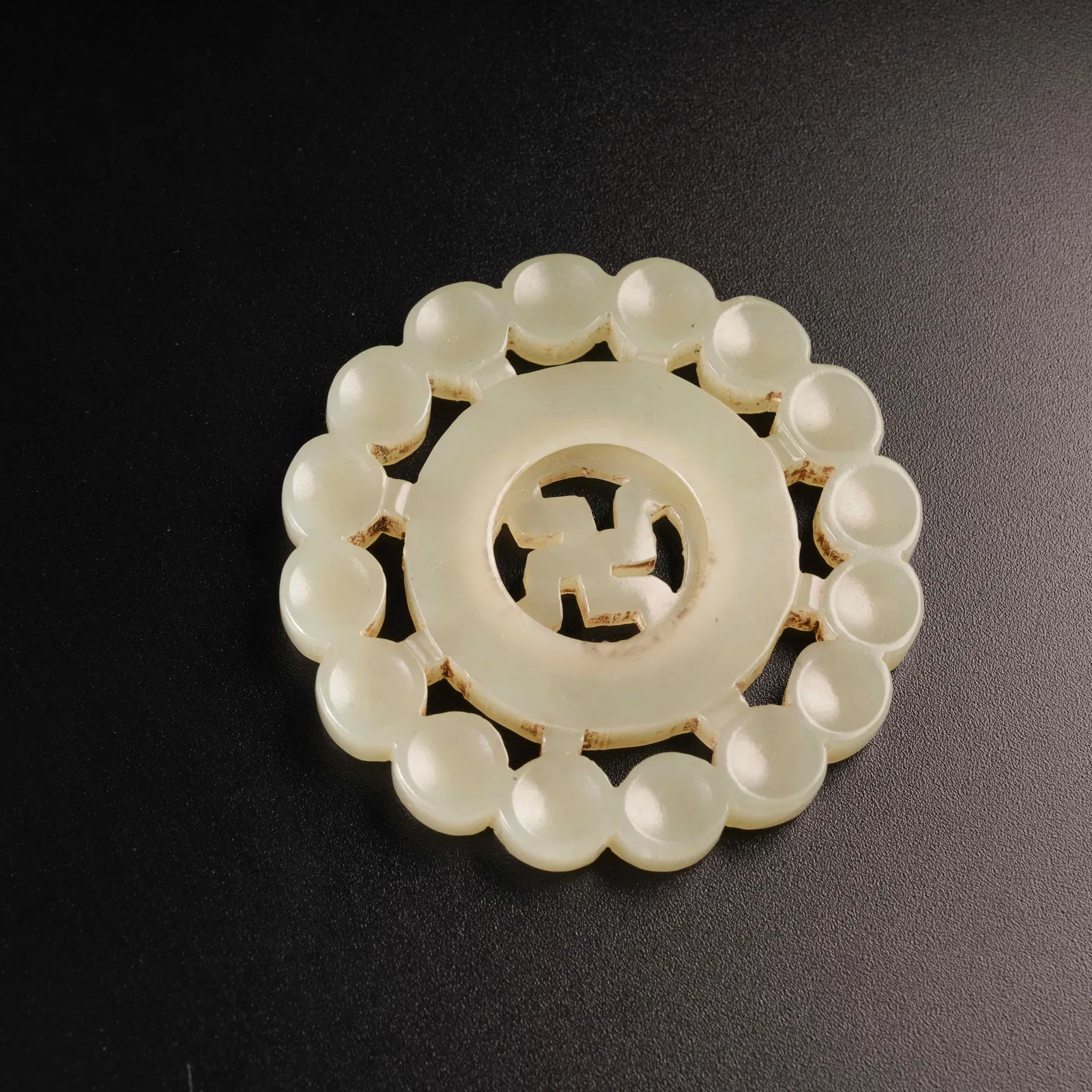 A HETIAN JADE SWASTIKA PENDANT