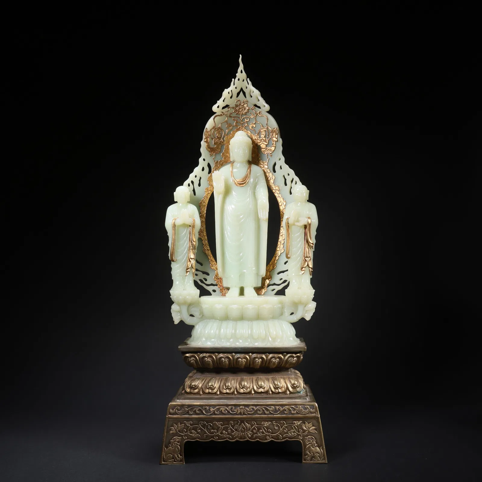 A HETIAN JADE THREE-TREASURE BUDDHA ON GILT-SILVER BASE