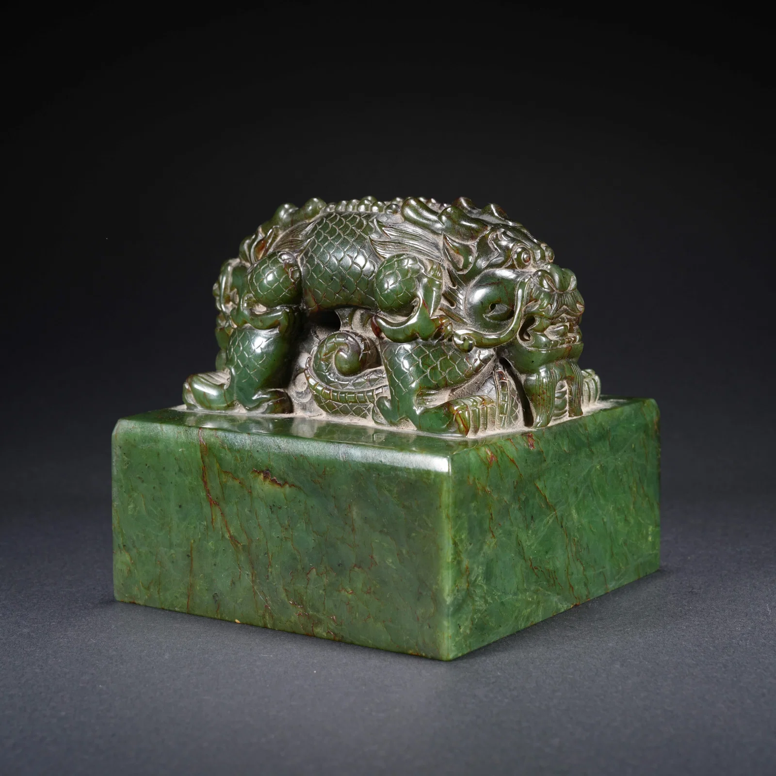 A HETIAN SPINACH GREEN JADE CARVED SEAL WITH DOUBLE-DRAGON FINIAL